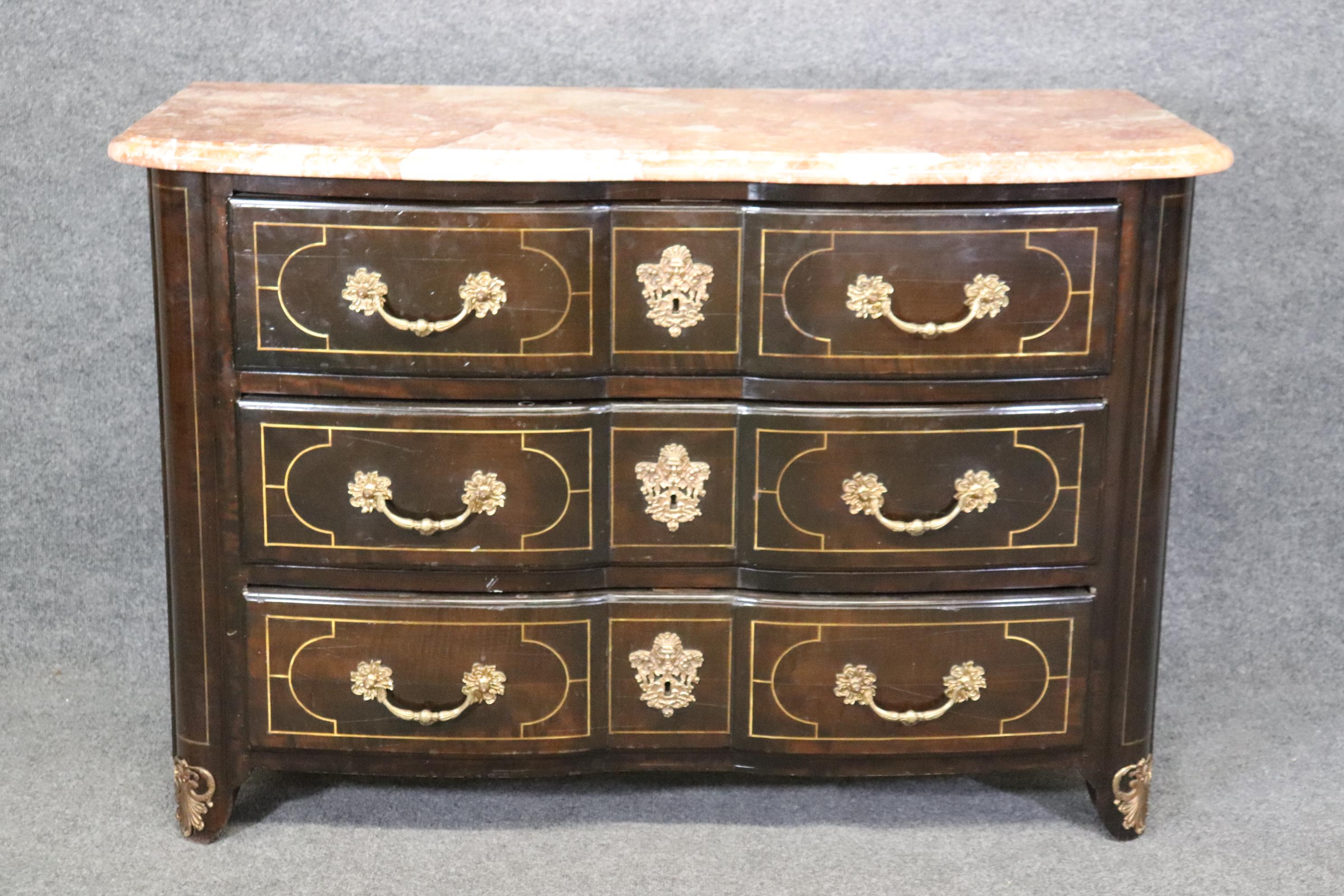 Dimensions: Height: 33 in Width: 49 1/4 in Depth: 22 3/4 in 

This vintage French Regency style marble top commode is a great example of quality french furniture! If you look at the photos provided, you will see the detailed brass inlay as well as