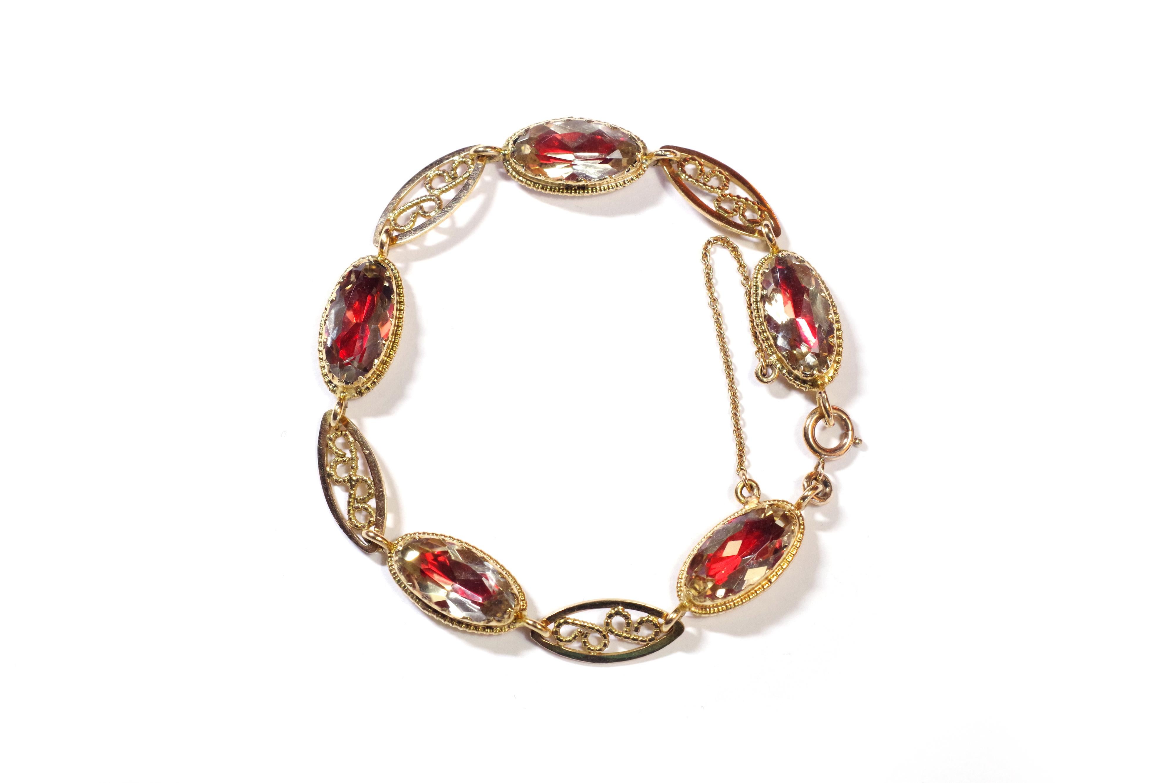 French regional citrine bracelet in yellow gold 18 karats. This bracelet is composed of five oval citrines faceted on red foils, set in a closed and curved setting. The gems are alternated with four openwork filigree links. These citrines are called