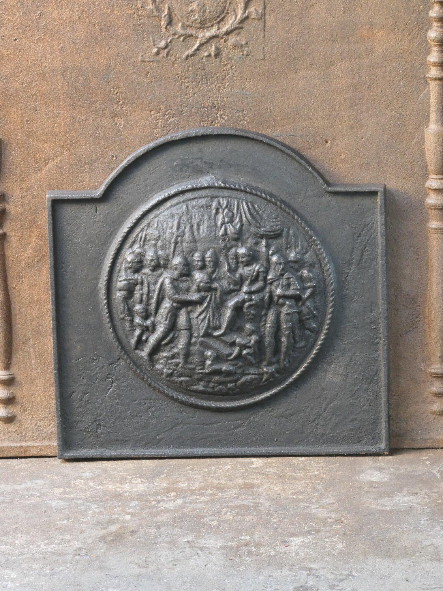 20th century French Napoleon III style fireback with a religious scene. 

The fireback is made of cast iron and has a black patina. It is in a good condition and does not have cracks.