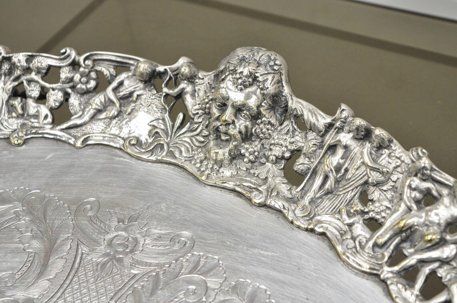 Antique French Renaissance Bacchanal Scene Silver Plated Bacchus Figural English Oval Salver Tray. Item features ornate cast frieze border of Bacchus, female mask heads, and classical mythological figures on stylized dolphin form legs. Tray further