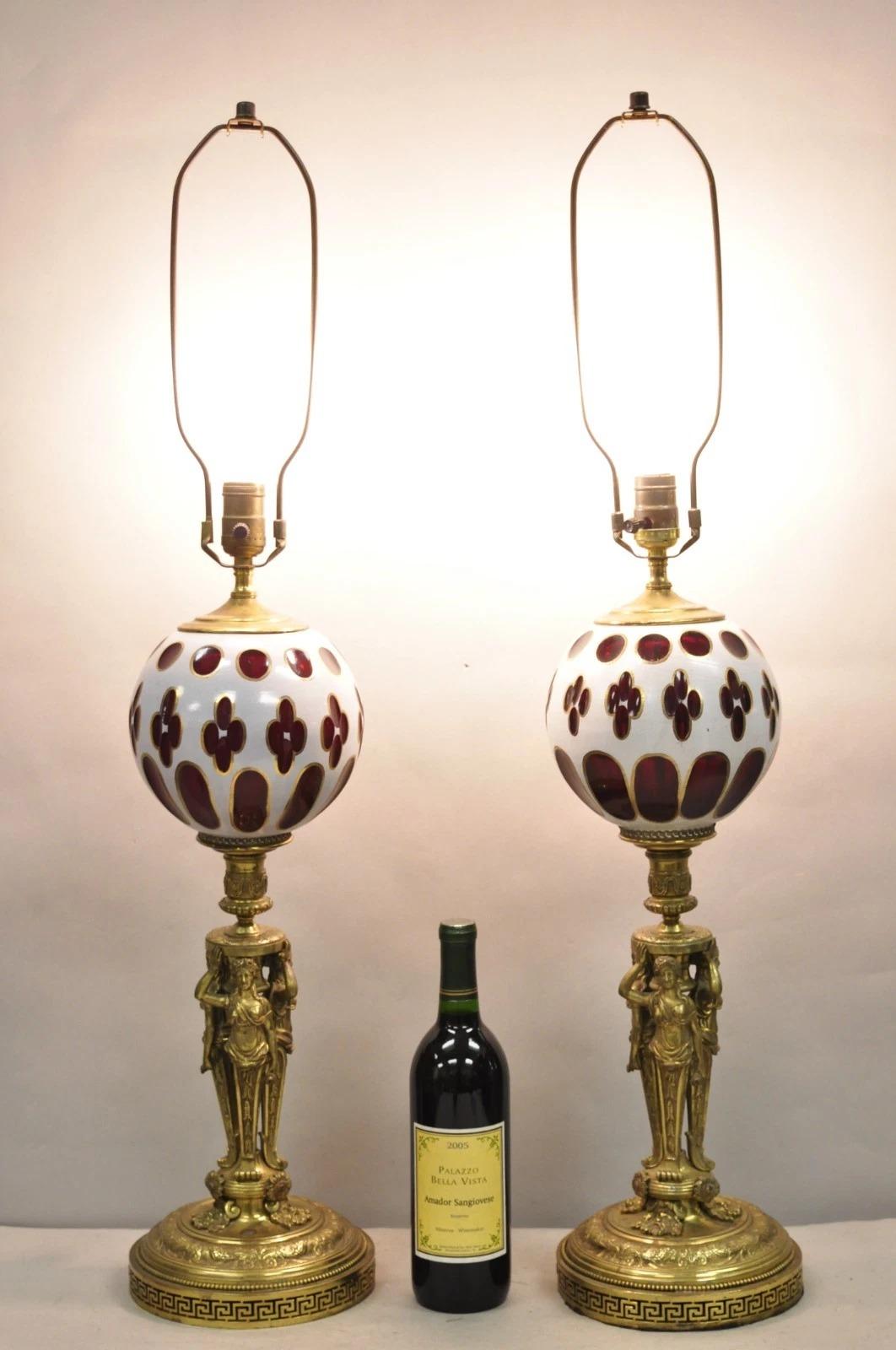Vintage French Renaissance Style Brass Figural Triple Maiden Base Cranberry Red & White Bohemian Glass Lamps - a Pair. Circa Mid 20th Century. Dimensions : 36