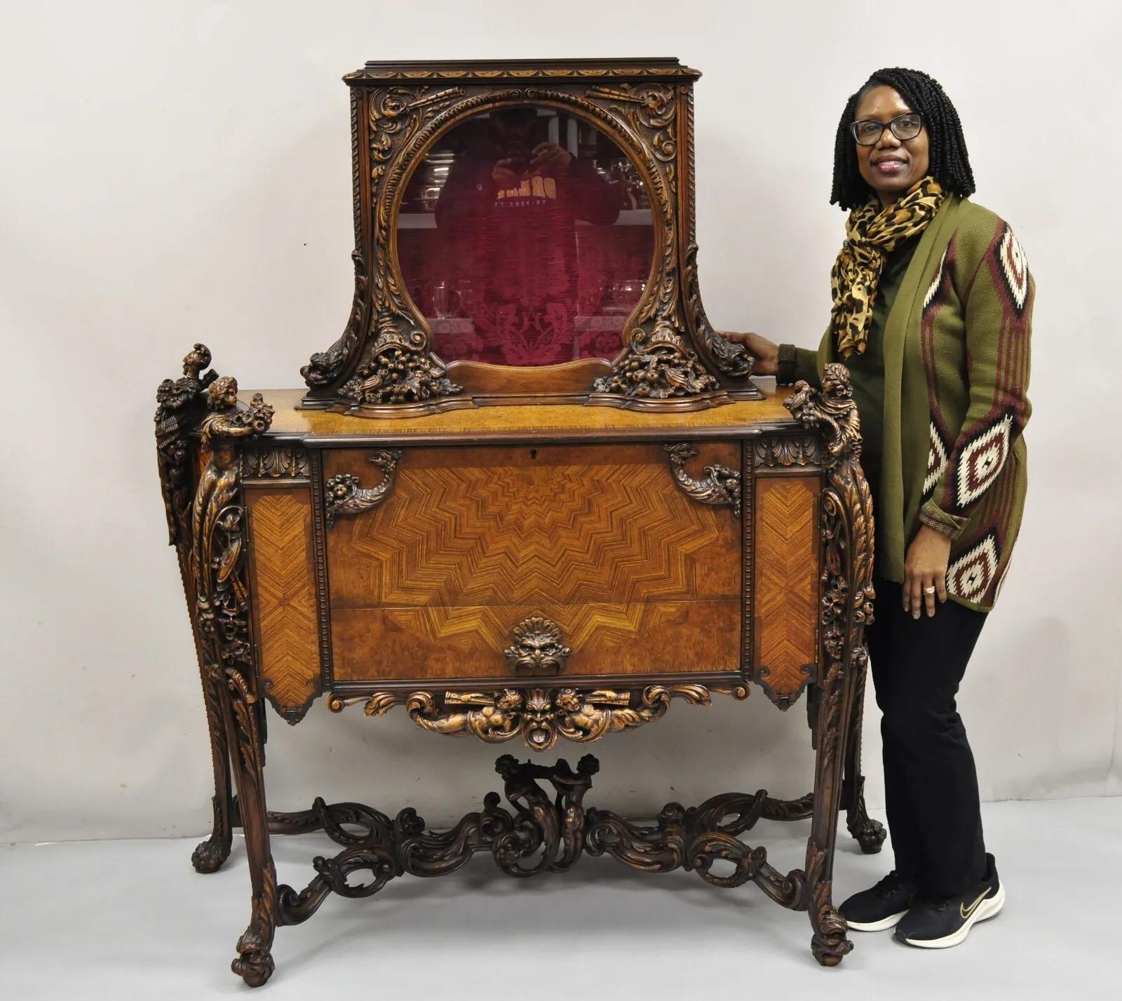 Antique French Renaissance Louis XV Style Figural Carved Walnut Curio Display Buffet. Item features stunning carvings throughout with maidens and armed soldiers holding flower bouquets, along with various dolphins, serpents, and cherubs with musical