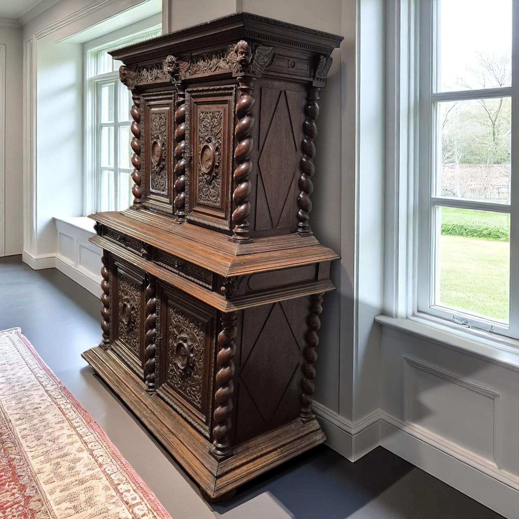 An imposing and richly detailed French Renaissance Revival buffet à deux corps, crafted in the 19th century from solid oak. This exceptional piece embodies the opulence and artistry of the era, with deeply carved decoration and architectural form