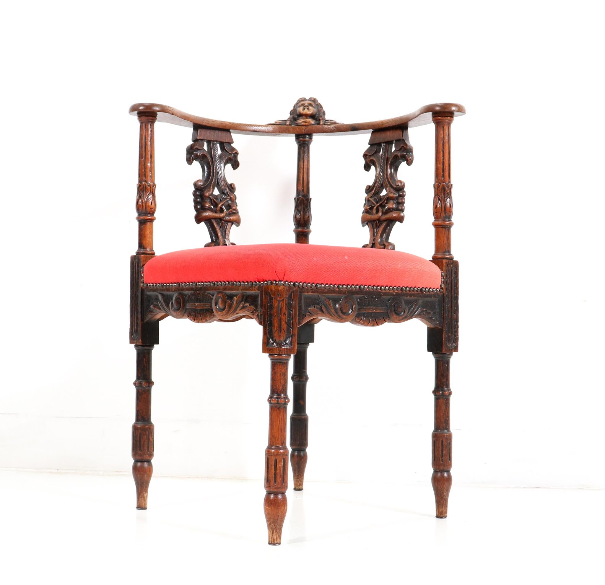 Stunning and rare Renaissance Revival corner armchair.
Striking French design from the 1890s.
Solid oak frame with original hand-carved decorative elements.
Original hand-carved female head at the back of the armrests.
The seat has been