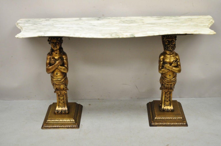 French Renaissance Victorian style gold figural console table with marble top. Item features a shaped marble top, carved wood base with male and female figures, gold painted finish, great style and form. Circa Mid 20th Century. Measurements: 29
