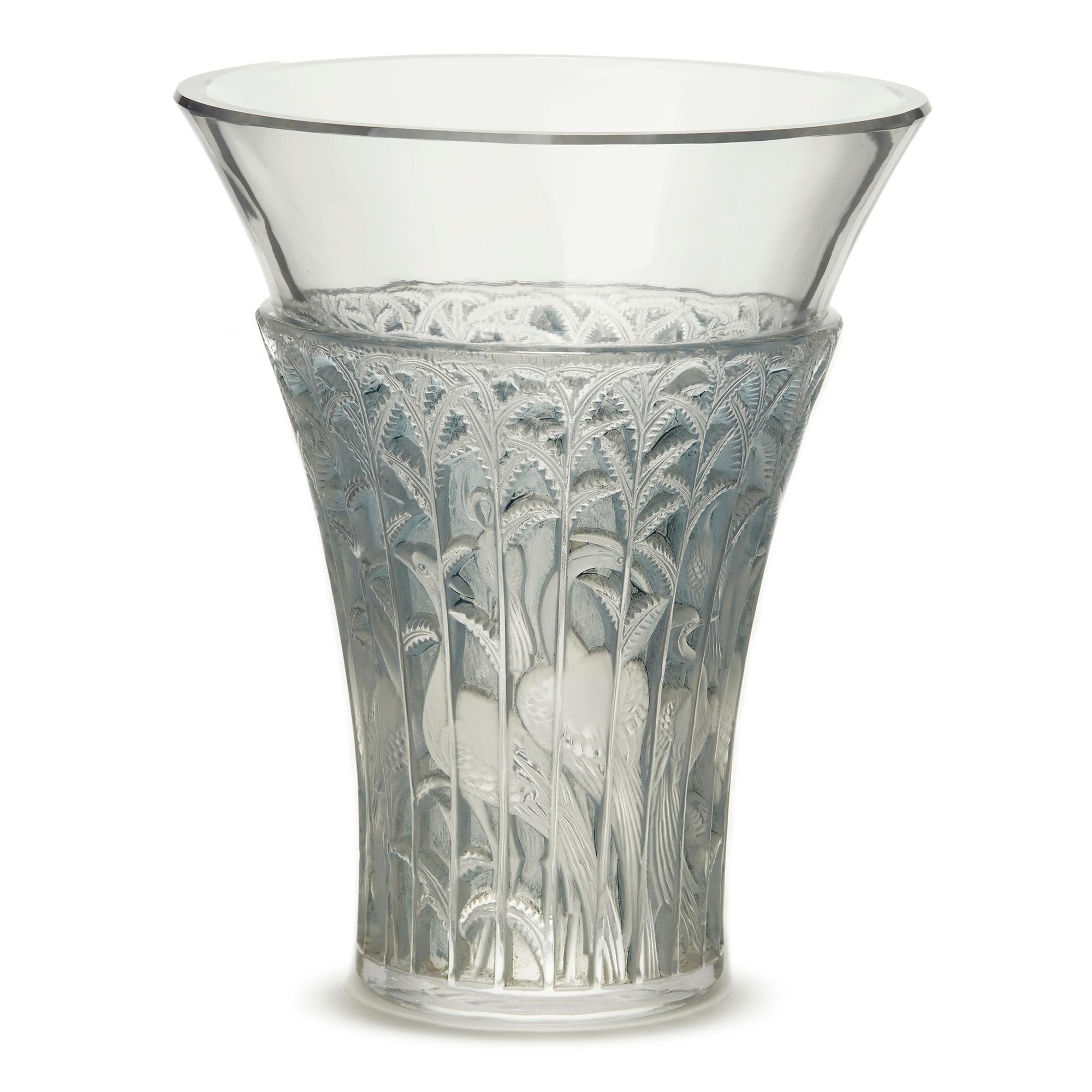 PLEASE NOTE: This piece is currently located in our Amsterdam office, please enquire for delivery times. 

A French Art Deco Lalique Ibis vase in clear, frosted and blue stained glass finely relief decorated around the body with Ibis birds amidst