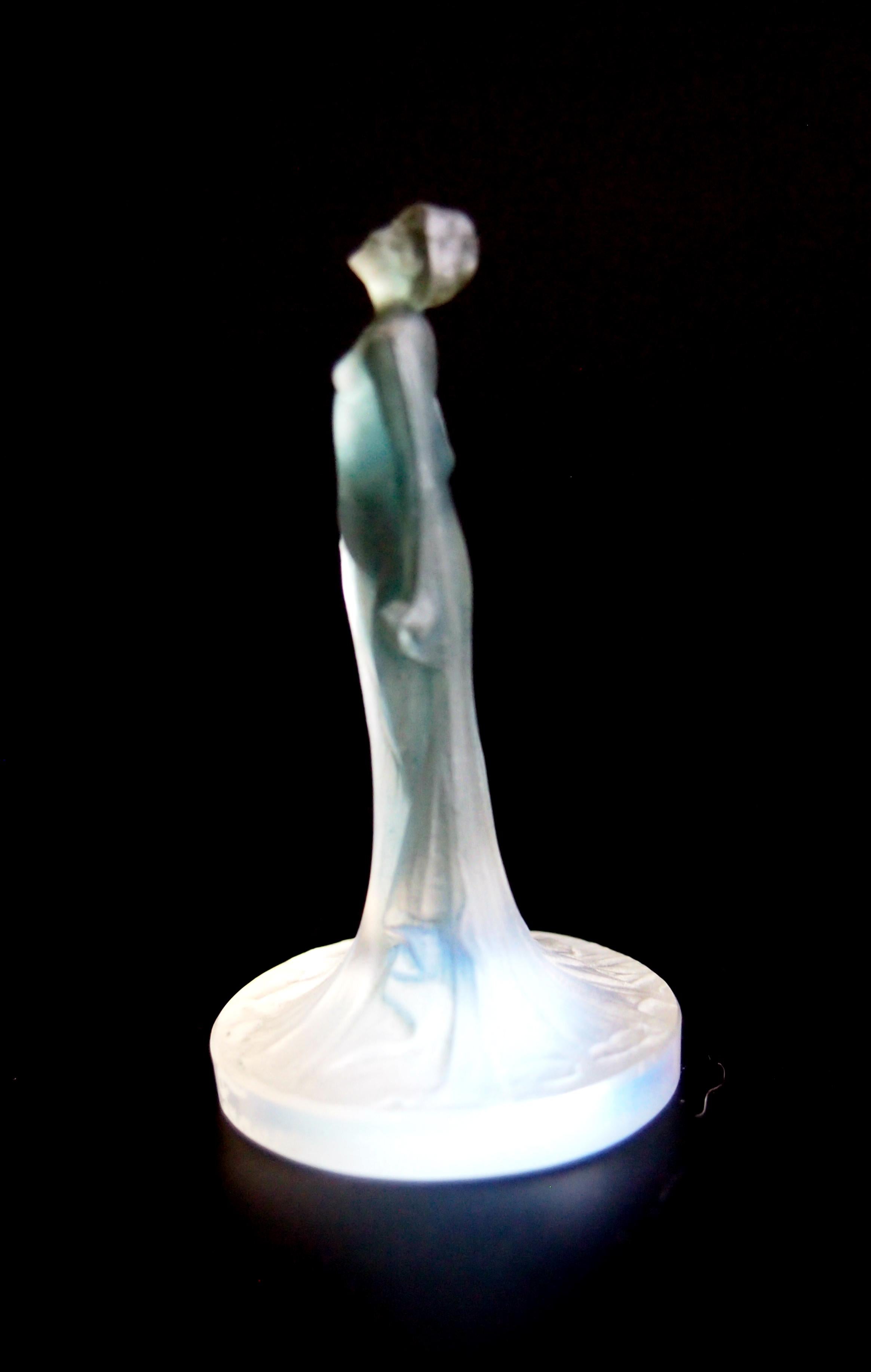A rare very early opal and blue stained Art Nouveau Rene Lalique 'Statuette Drapee' cachet, dating from 1913 (Marcilhac ref:181). It depicts a tiny scantily dressed lady. Cachets were made so you could have your initials cut into the base and then