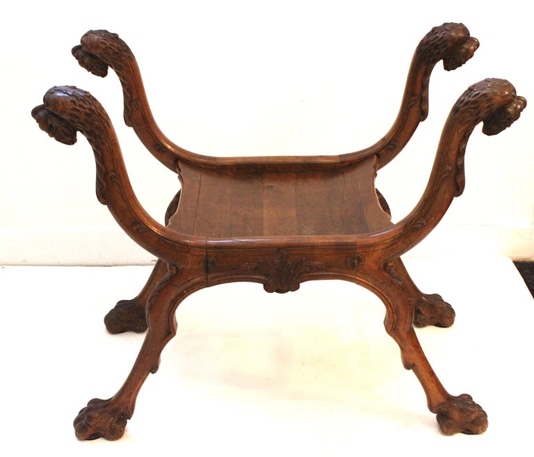 Stunning French Renaissance style curule bench all original carved wood, including the original curved wood seat. The rim of the seat is 14 1/2