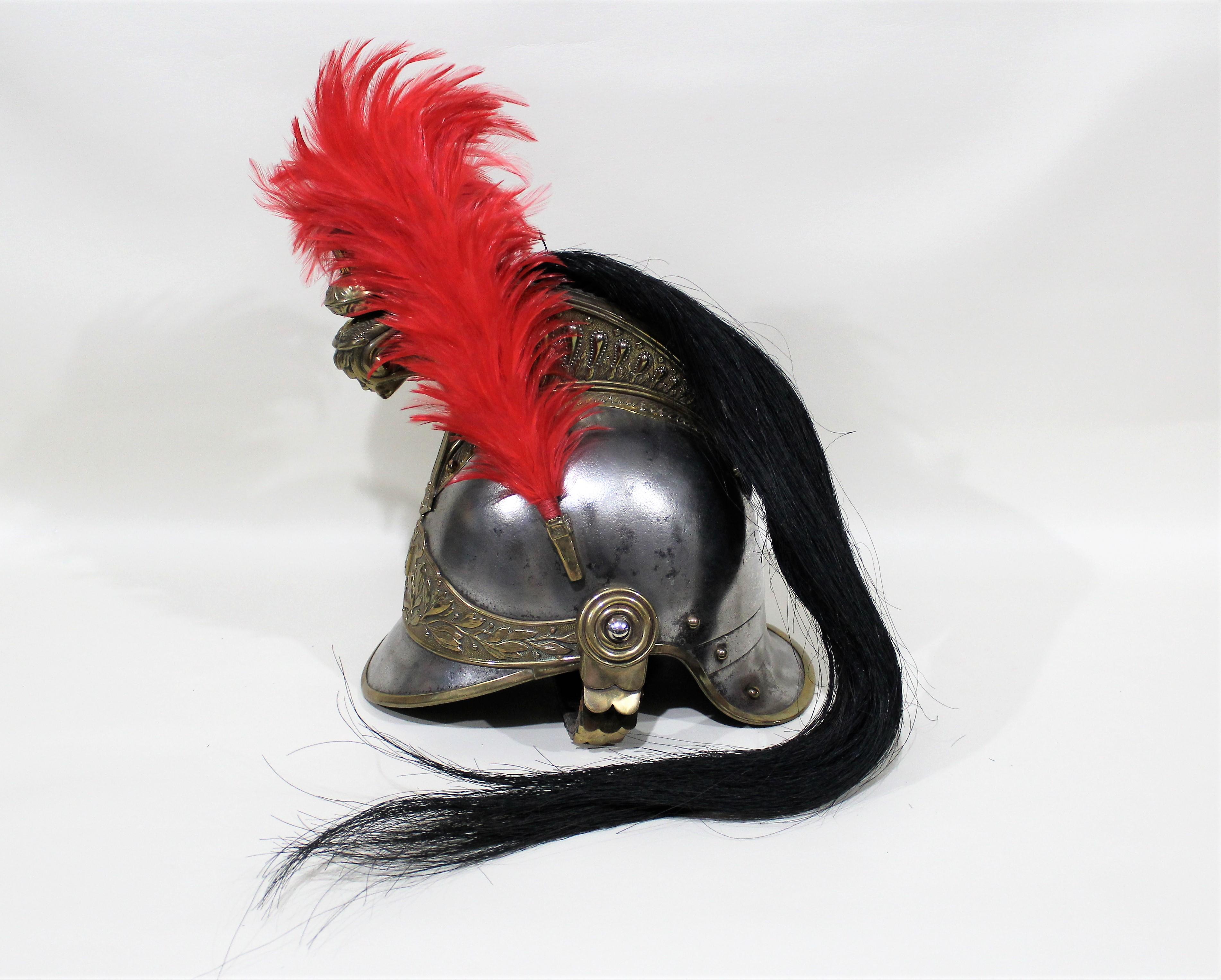 French Republican Guard of the City of Paris Cuirassier helmet made by Siraudin & Hersant. The body is silvered metal with the edges banded in gilt metal. The gilded comb is decorated on both sides with volutes and laurel leaves and the front bears