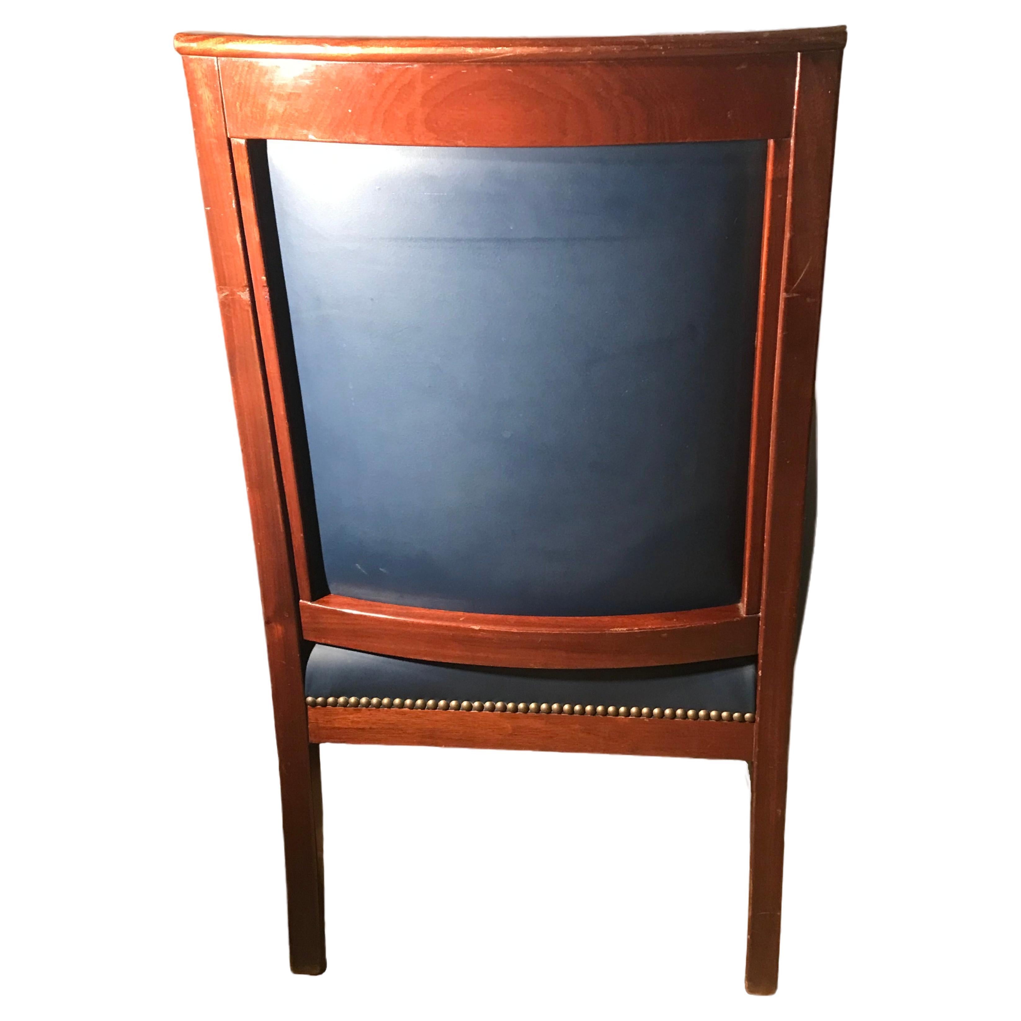 Explore our pretty French Restauration Armchair, crafted circa 1870-80. Adorned with intricate carvings, this armchair is constructed from luxurious Mahogany wood and features a stylish blue leather upholstery. In good original condition, this chair
