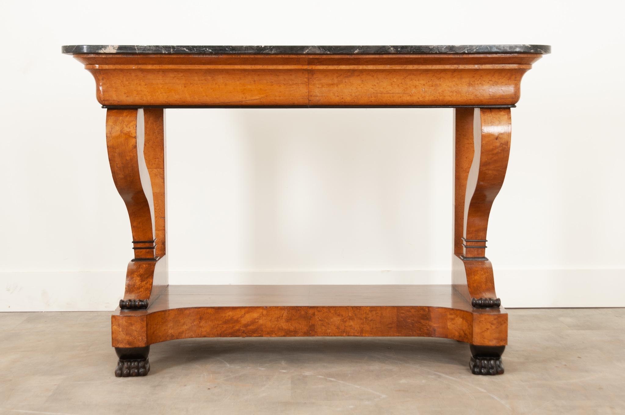 A elegant and large scale restoration console with a beautiful shaped black and white piece of marble. The top elegantly cantilevers over its base and is classic of the Restoration period. Thick burl birch veneer has a warm honey coloring and