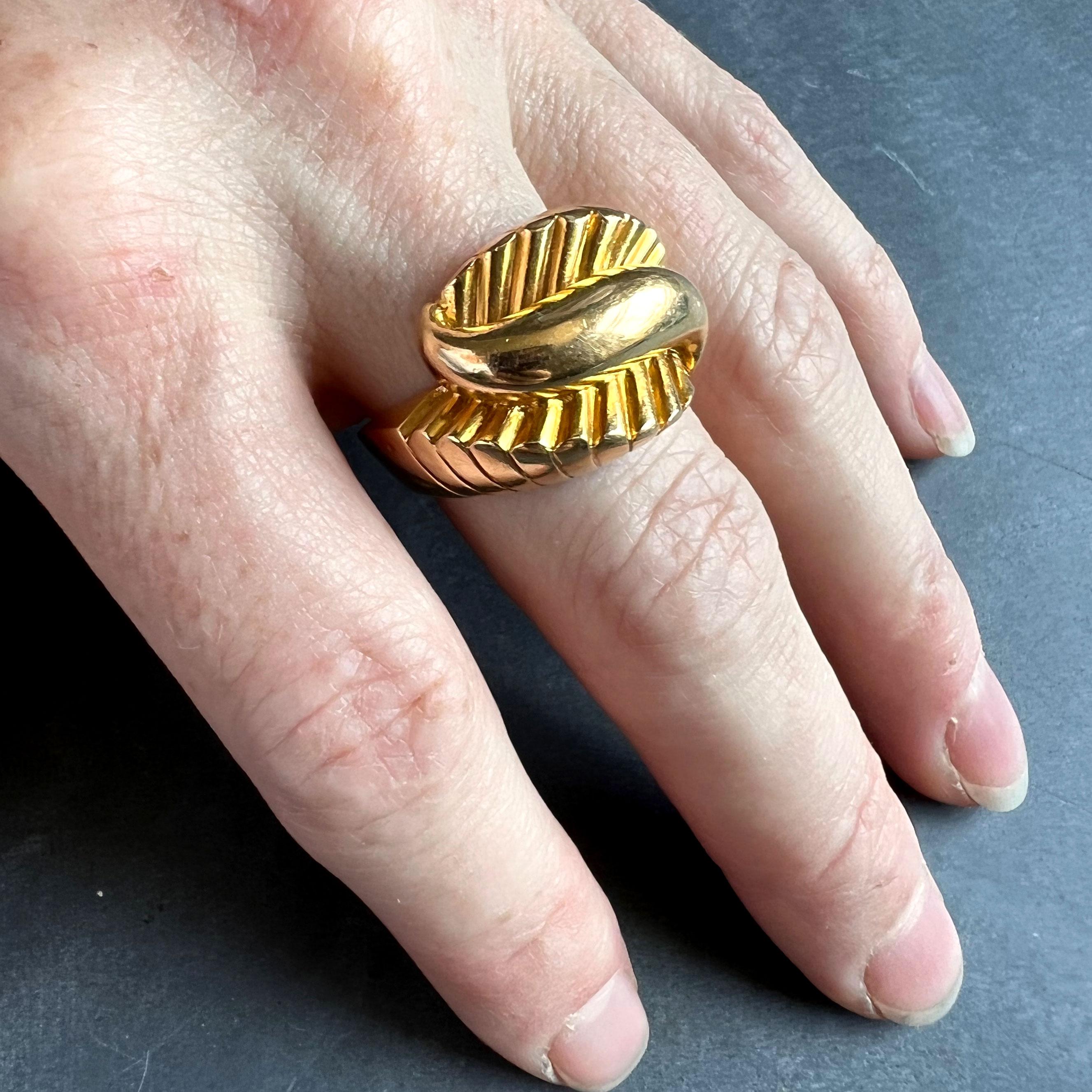 A French 18 karat (18K) yellow gold retro ring with large central swirl. Stamped with the eagles head for French manufacture and 18 karat gold.

Dimensions: 1.65 x 2.3 x 2.8 cm 
Ring Size: US - 8.25 (UK - Q)
Weight: 11.82 grams
