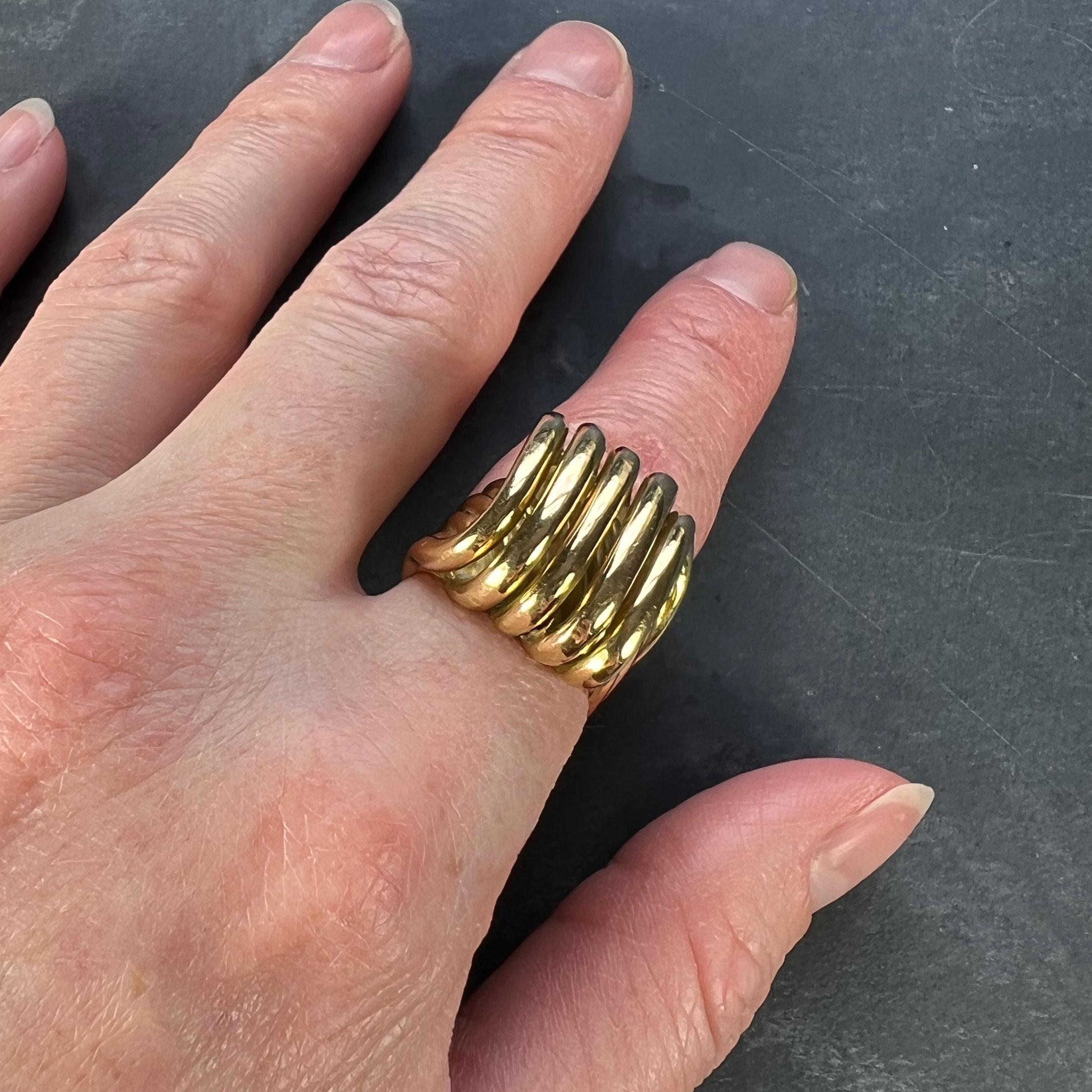 A heavy 18 karat (18K) yellow gold ring designed as a bold, three-dimensional, coiled spring in the Retro style. Stamped with the eagle mark for 18 karat gold and French manufacture.

Dimensions: 2.7 x 2 x 2 cm 
Weight: 25.36 grams.
Ring Size: K
