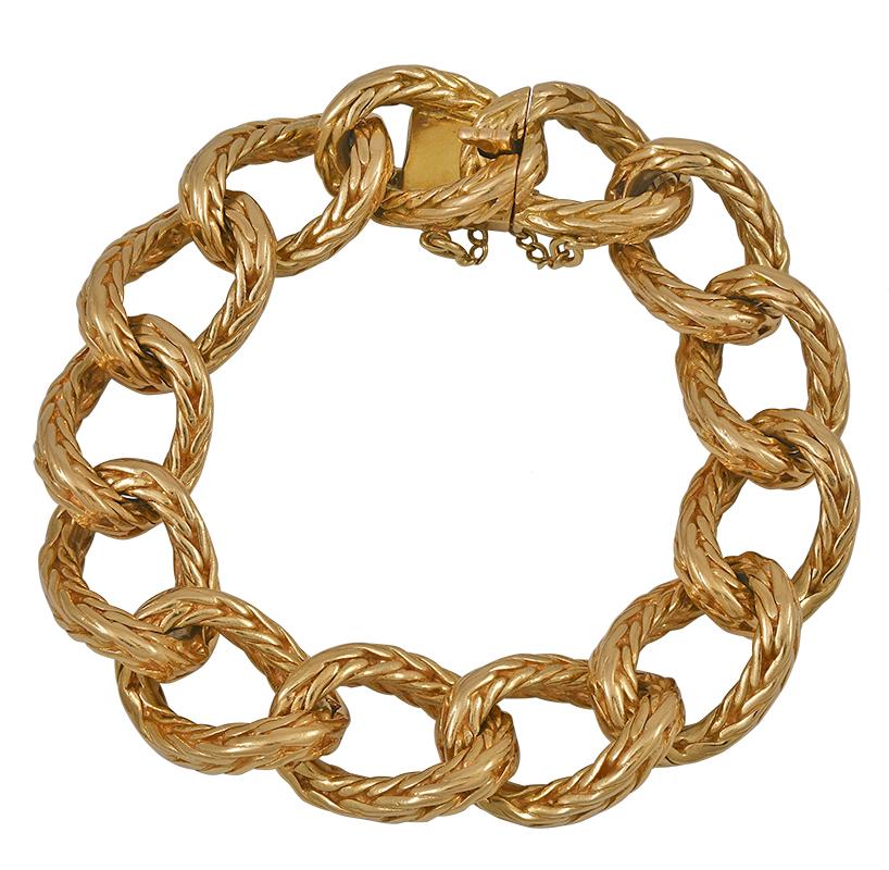 The heavy 18kt yellow gold bracelet designed as a highly flexible row of handmade braided oval curb links, maker's mark for Rollang et Fils et Cie, stamped 750, French, ca. 1945, measuring app. 8 inches long by 5/8 inch wide, weighing 107.7 grams.