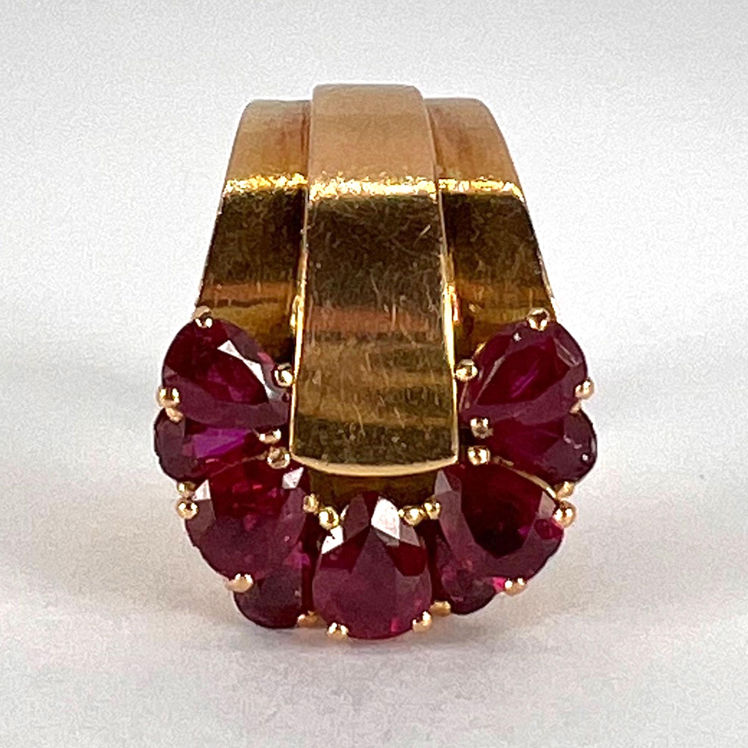 A French 18 karat (18K) yellow gold retro ring designed as a buckle with a double-level spray of pear-shaped natural rubies. 

Stamped with the eagles head for French manufacture and 18 karat gold with maker’s mark for Bourquin.

Dimensions: 1.7 x