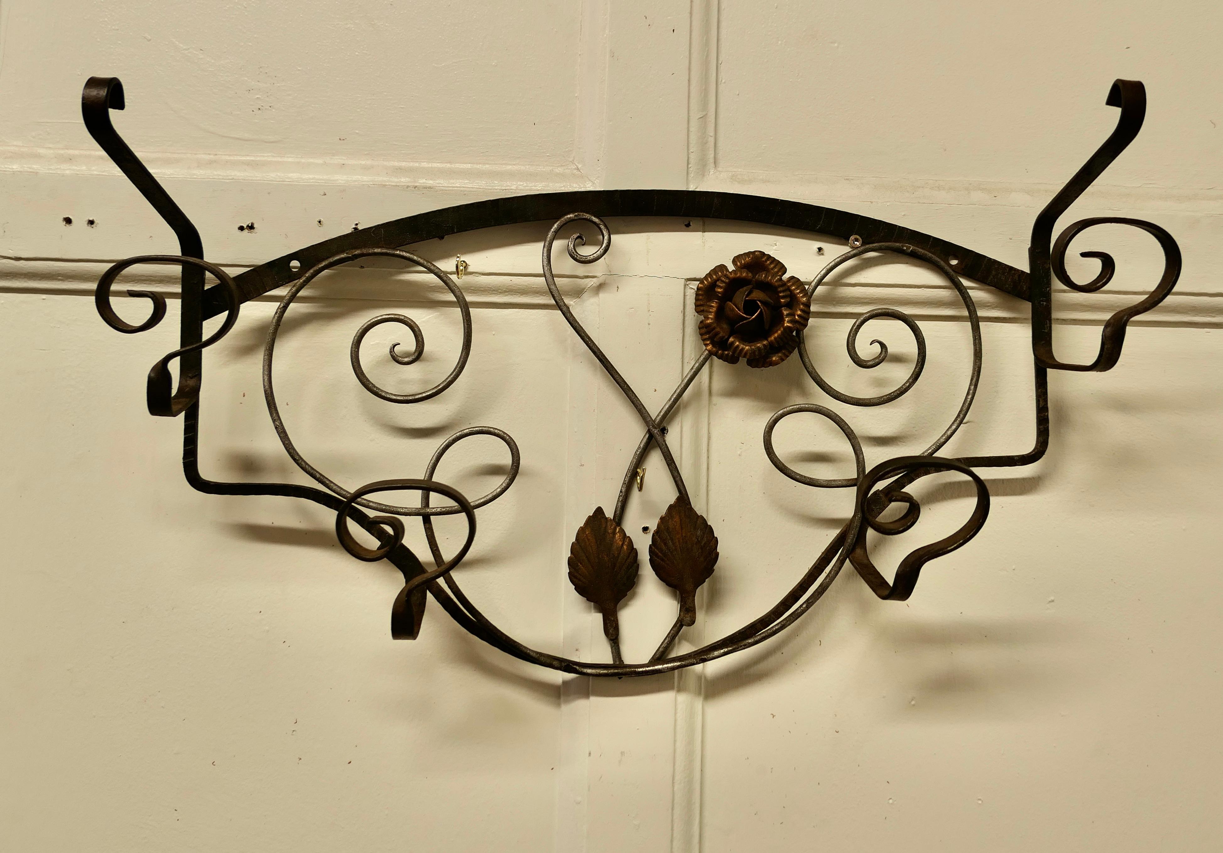 French Retro Chic Iron and toleware hat and coat rack 

 This delightful French 60s coat rack is decorated with toleware roses and it has 4 wrought iron hooks
A useful piece for a bathroom or cloakroom anywhere where space is limited

The rack