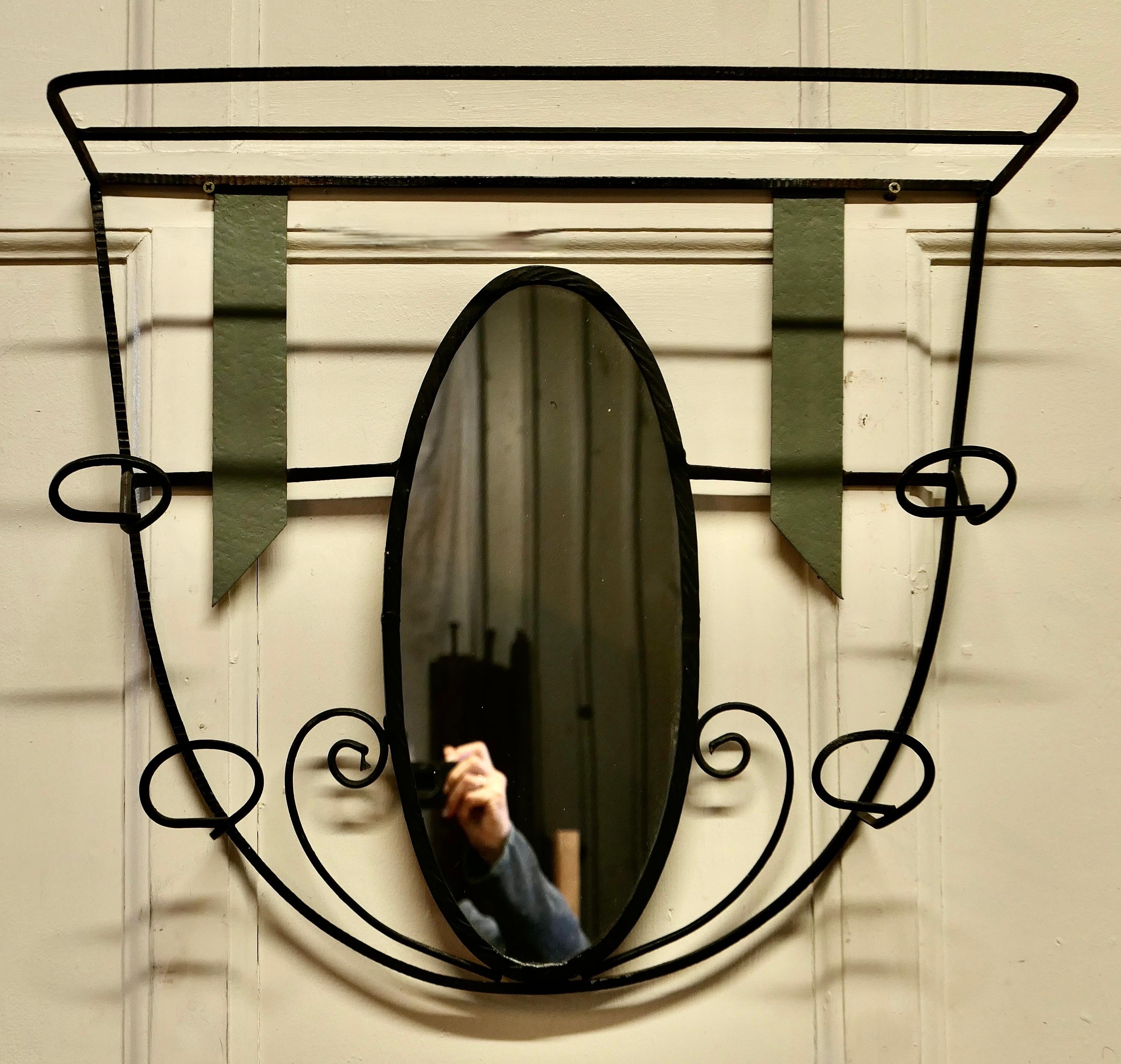 French retro chic iron and toleware hat and coat rack with oval mirror.


 This delightful French 60s coat rack has an Oval mirror decorated with toleware ribbons, it has 4 wrought iron hooks and a luggage shelf over the top
A useful piece for a