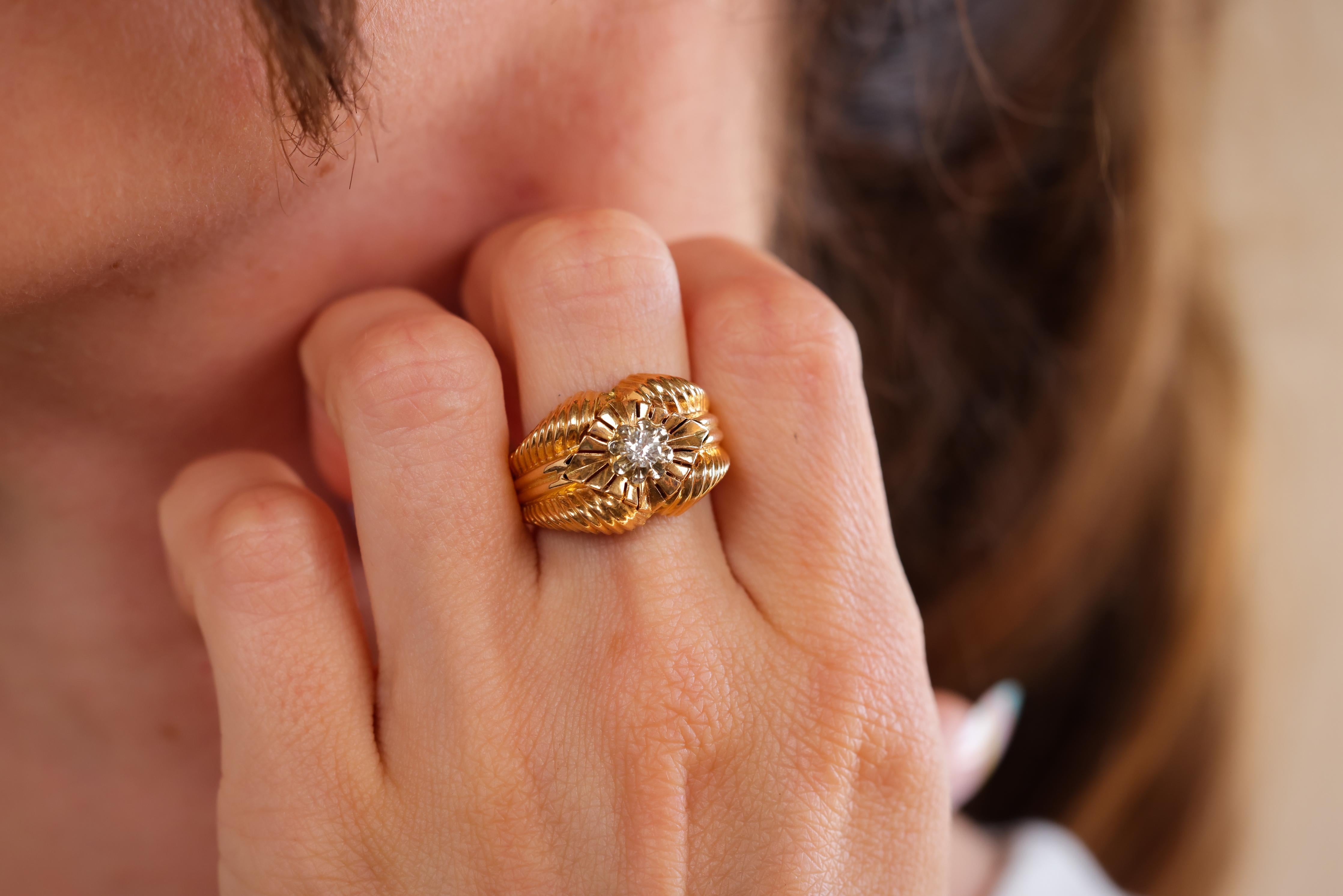 Center Stone: Diamond 
Cut: Round Brilliant 
Weight: Approximately 0.15 Carats
Color: I-J 
Clarity: SI
Metal: 18k Yellow Gold 
Era: Retro 
Circa: 1940s
Hallmarks: French Eagle Head and Makers Mark
Size: 7-3/4 and can be resized 
Gram weight: 5.3
