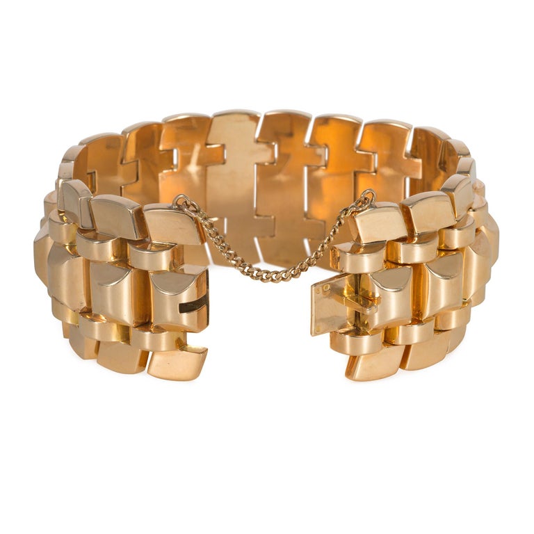 A Retro rose gold tank bracelet of stepped design with a central spine of sugarloaf-shaped links, in 18k. France
