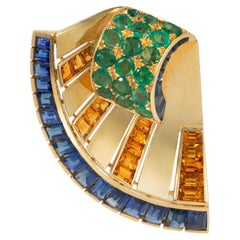 French Retro scroll brooch with sapphires and emerald
