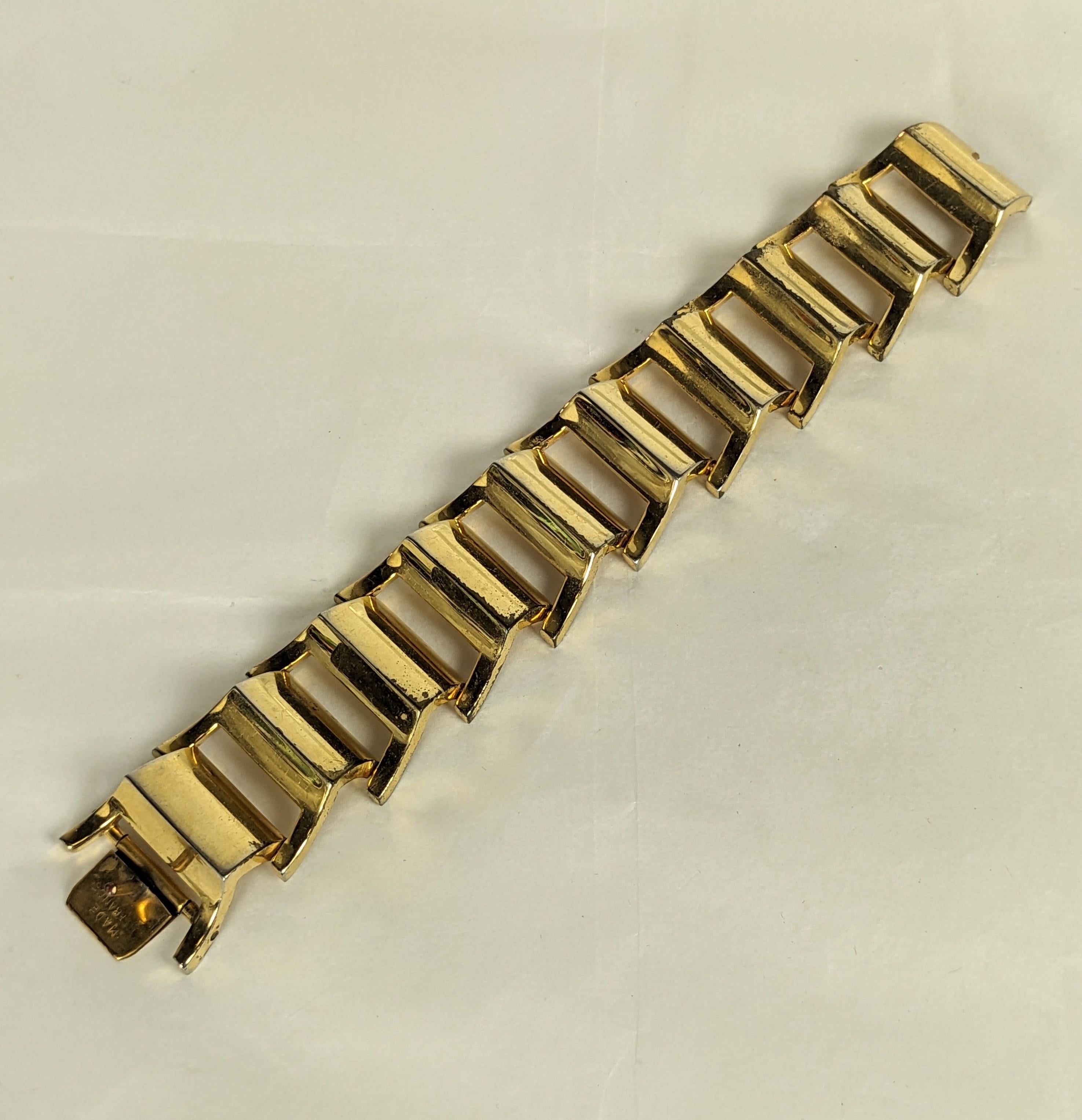 Striking French retro tank bracelet about 1940. Of gold plated base metal with trapezoid shaped articulated links. Marked  France, Very Good Condition.  L. 7 