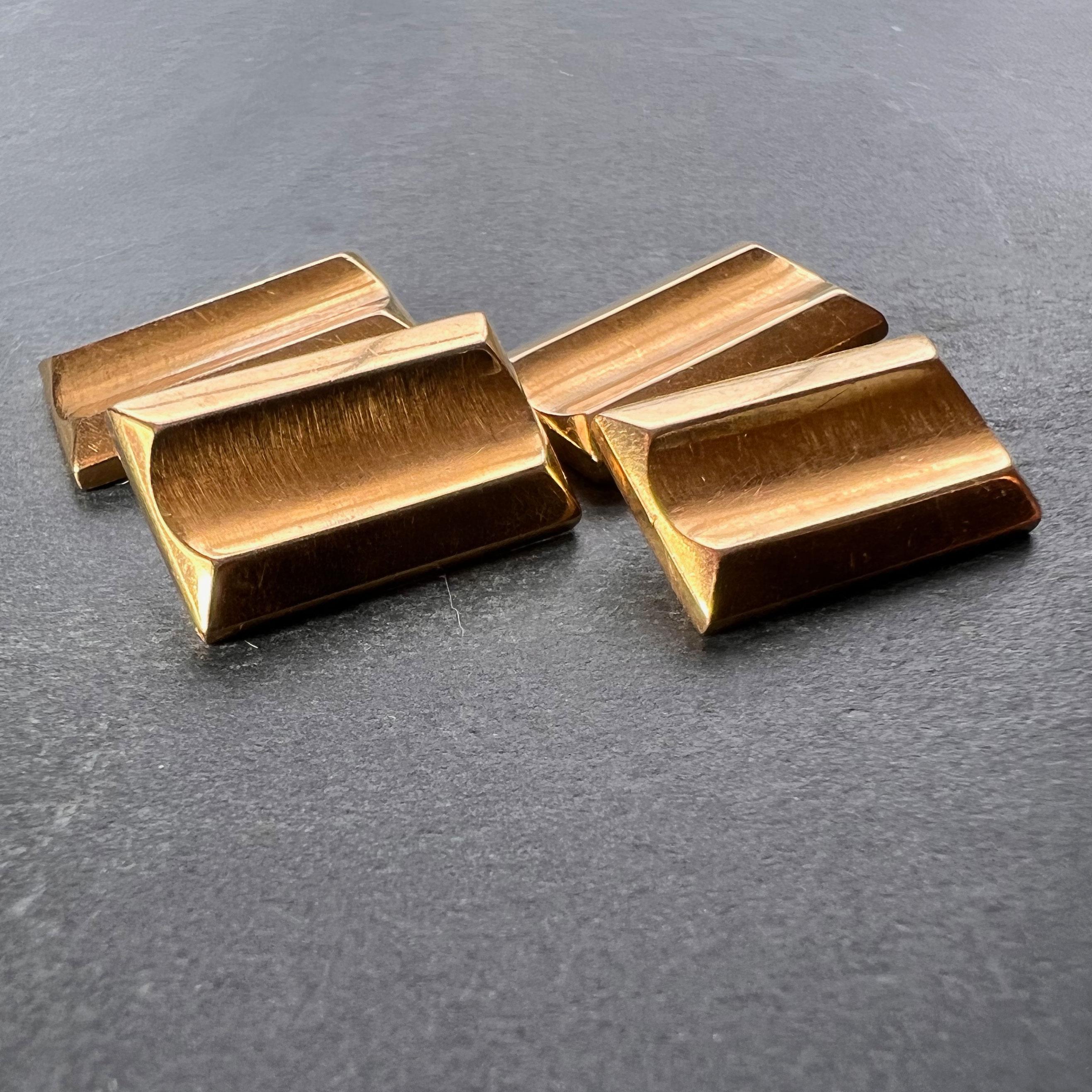 A pair of 18 karat (18K) yellow gold cufflinks, each designed as a rectangle with geometric raised edges in the Retro ‘Tank’ style. Stamped with the eagle mark for 18 karat gold and French manufacture and an unknown maker’s mark.
 
Dimensions: 1.5 x