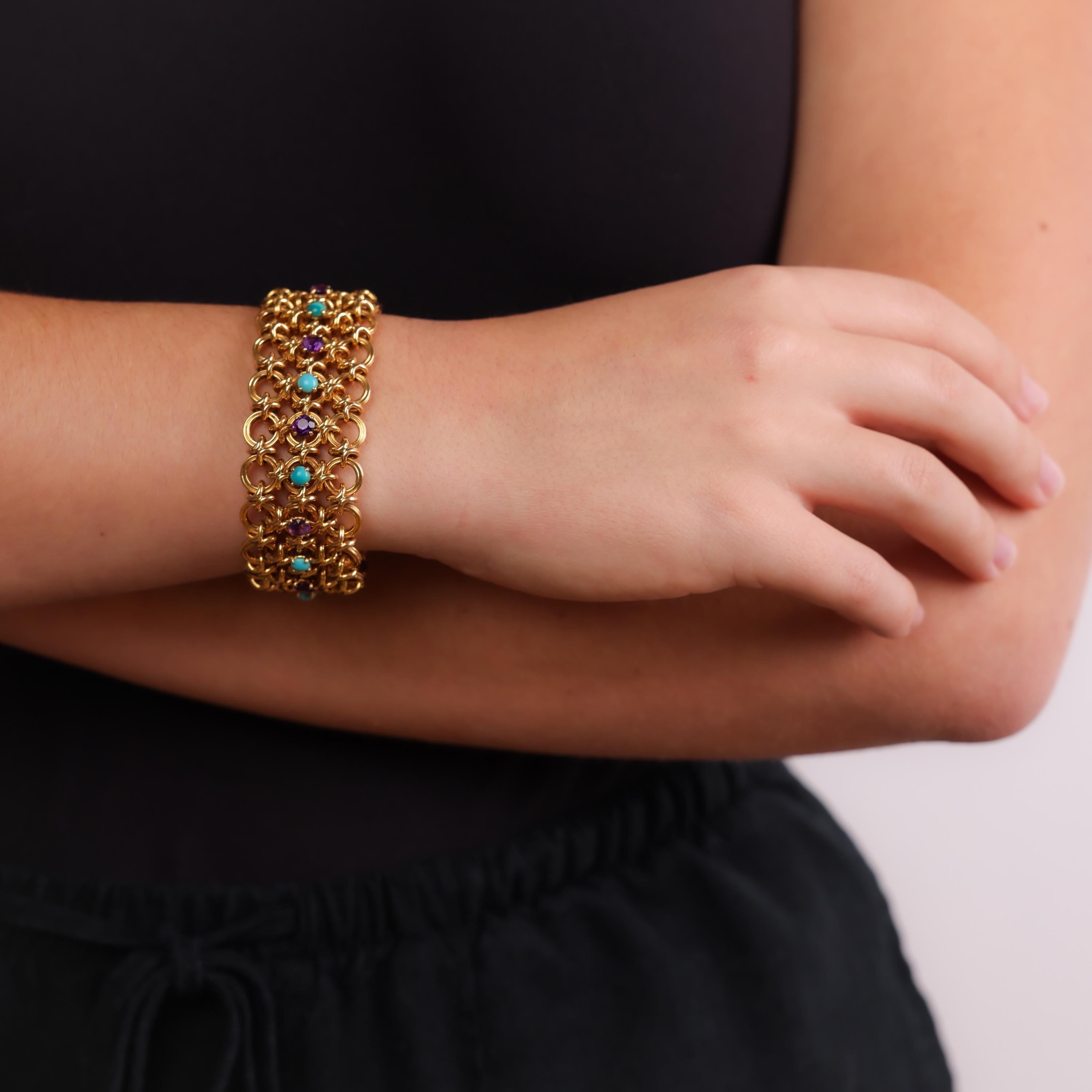This Retro 18k yellow gold bracelet showcases a striking combination of cabochon turquoise and round amethyst stones, creating a bold and vibrant design from the 1940s.

Center Stone: 9 cabochon cut turquoise and 9 round cut amethyst
Metal: 18K