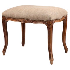 French reupholstered Louis XV style footstool in carved wood