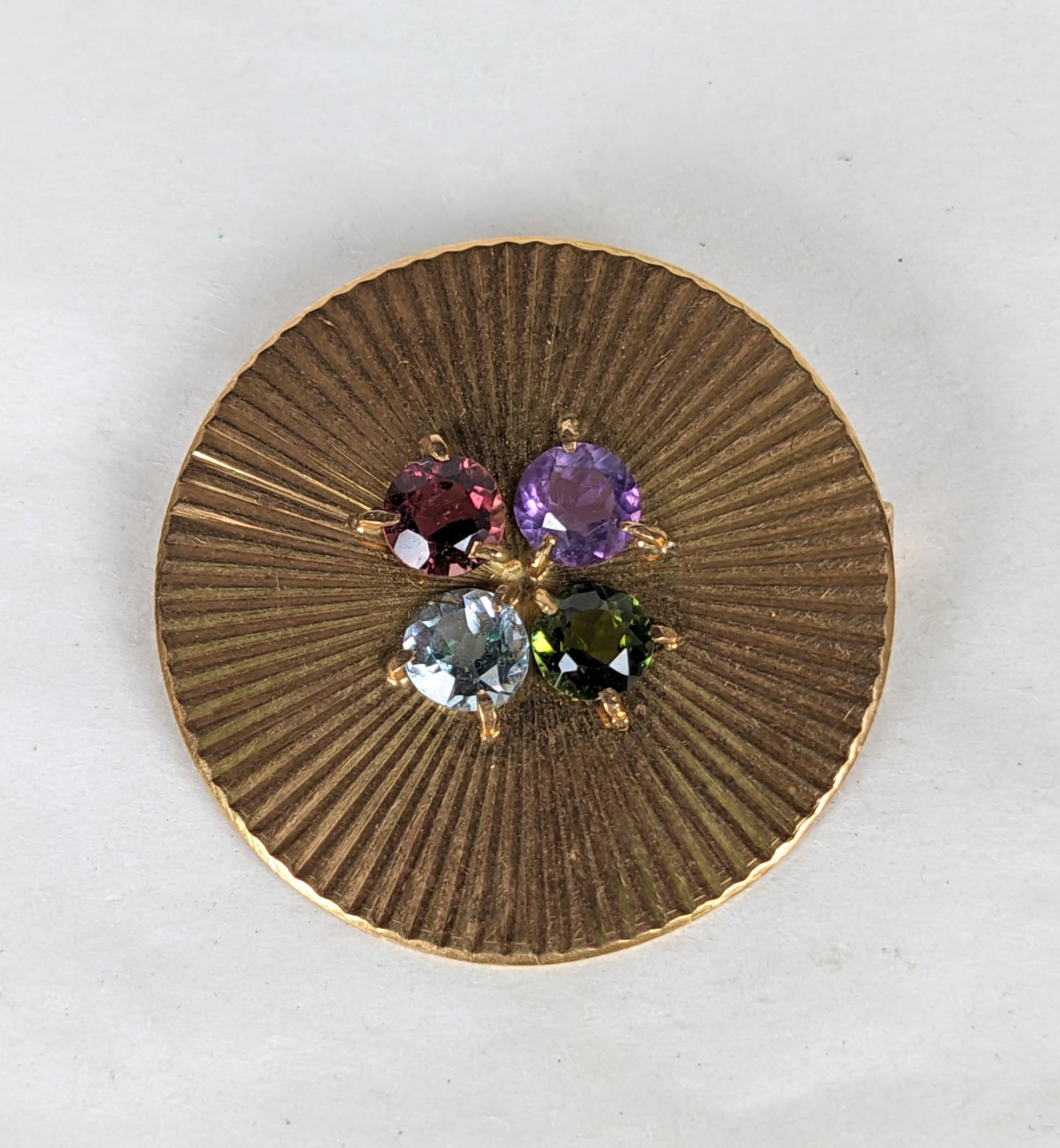 Elegant French Ribbed Gold Circle Brooch from the 1950's set with semiprecious stones such as amythest, garnet, tourmaline and blue zircon. 1.25