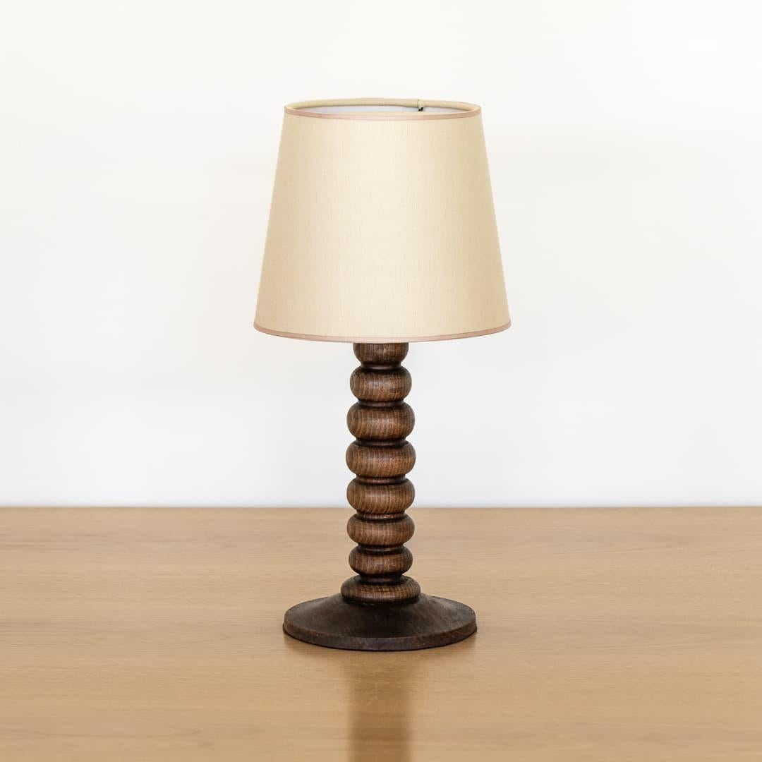 Beautiful vintage wood table lamp from France, 1940s. Thick carved wood ribbed grooves in stem with original dark wood finish showing nice age and patina. New cream linen shade with tan trim and newly re-wired. Takes one E12 base bulb, 25 W or