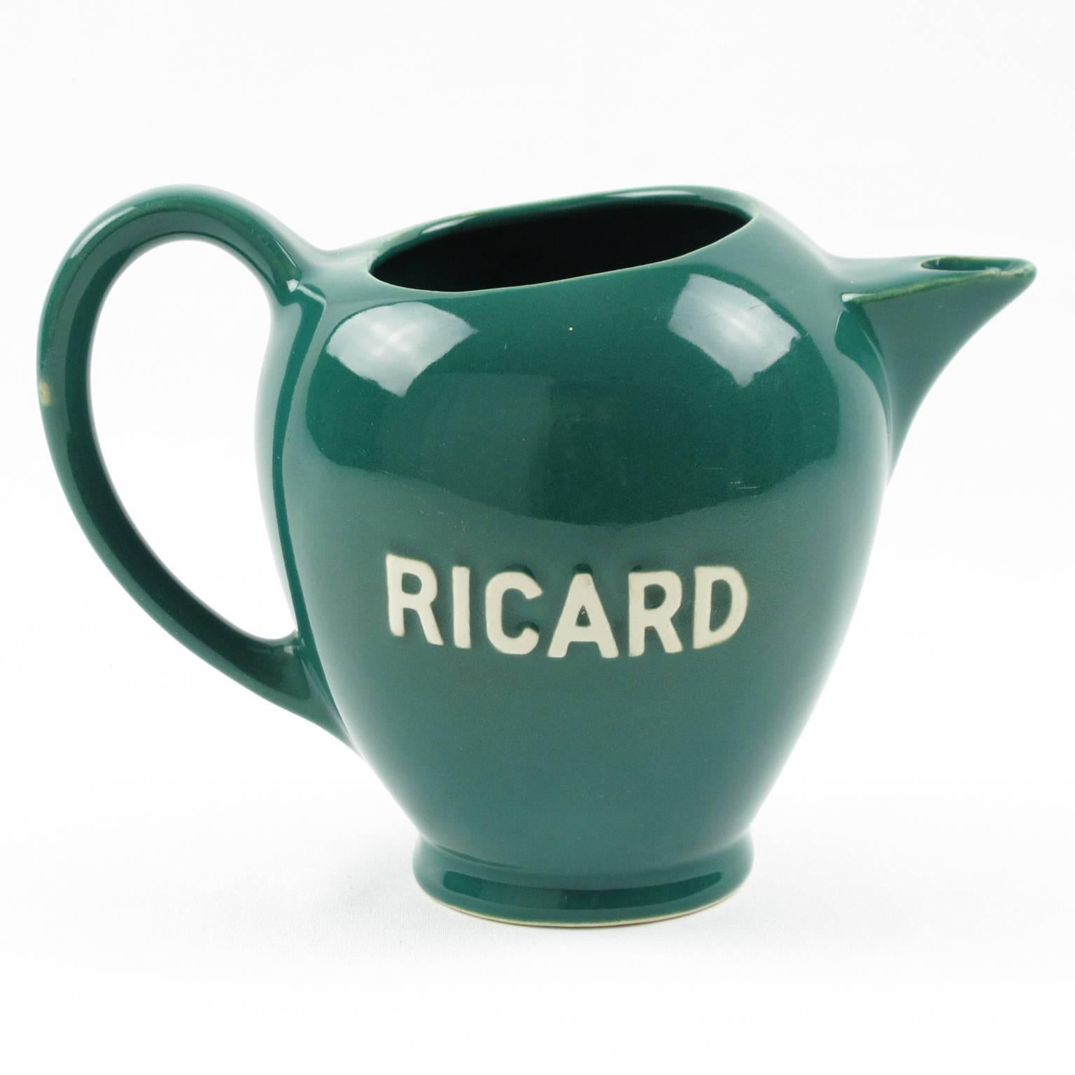 Iconic French cafe barware accessory. Set of four original Ricard water pitcher, pot, jug in glazed earthenware with embossed marking on both side. Assorted colors of teal, yellow, off-white and brown. These pitchers are beautiful 1950s and 1960s