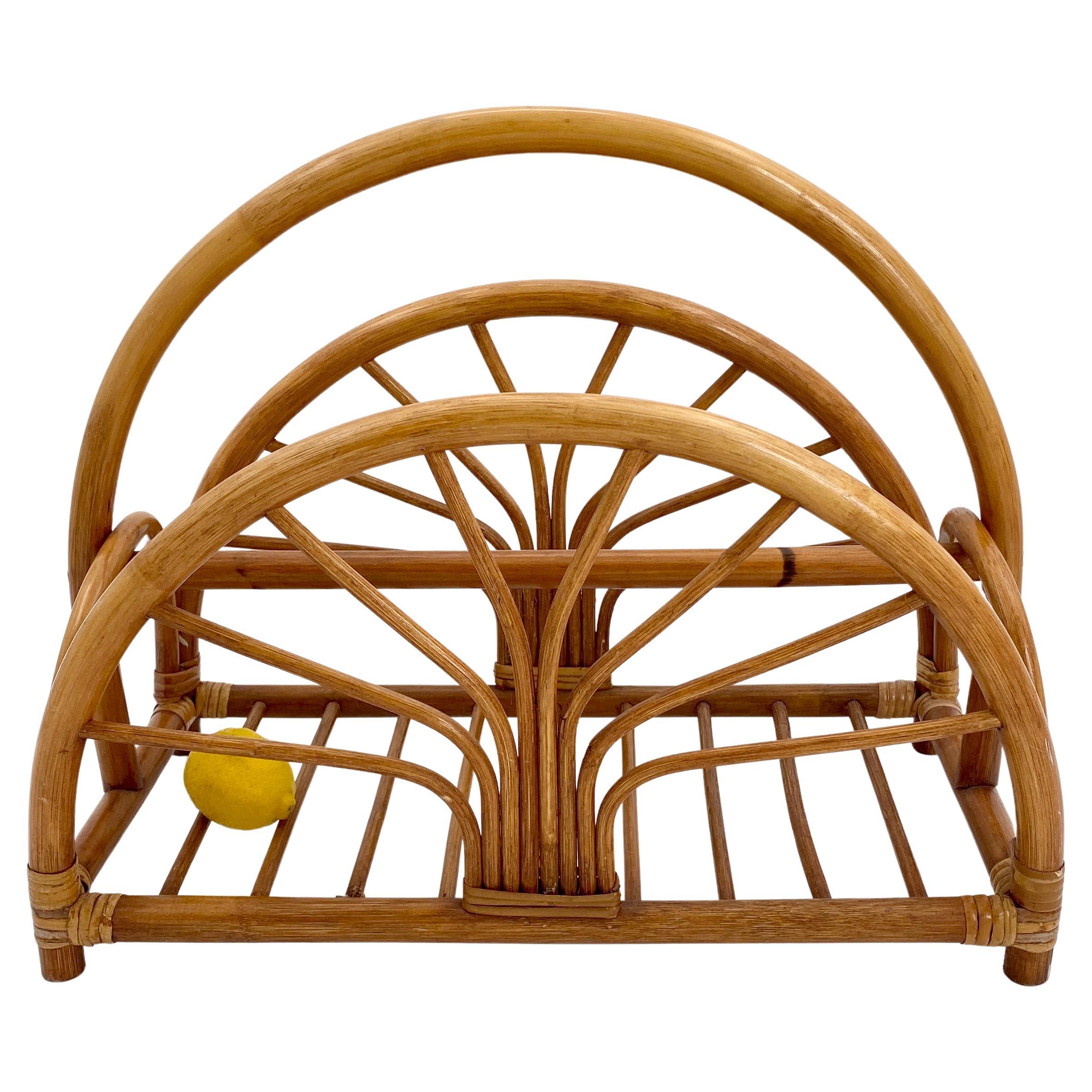 Italian Mid-Century Modern Demi-lune Shaped French Riviera Magazine Rack.

The rack is quite deep and has two arches as side. It is made in bamboo and rattan with two different shades of brown. Made in Italy in the 1960s.