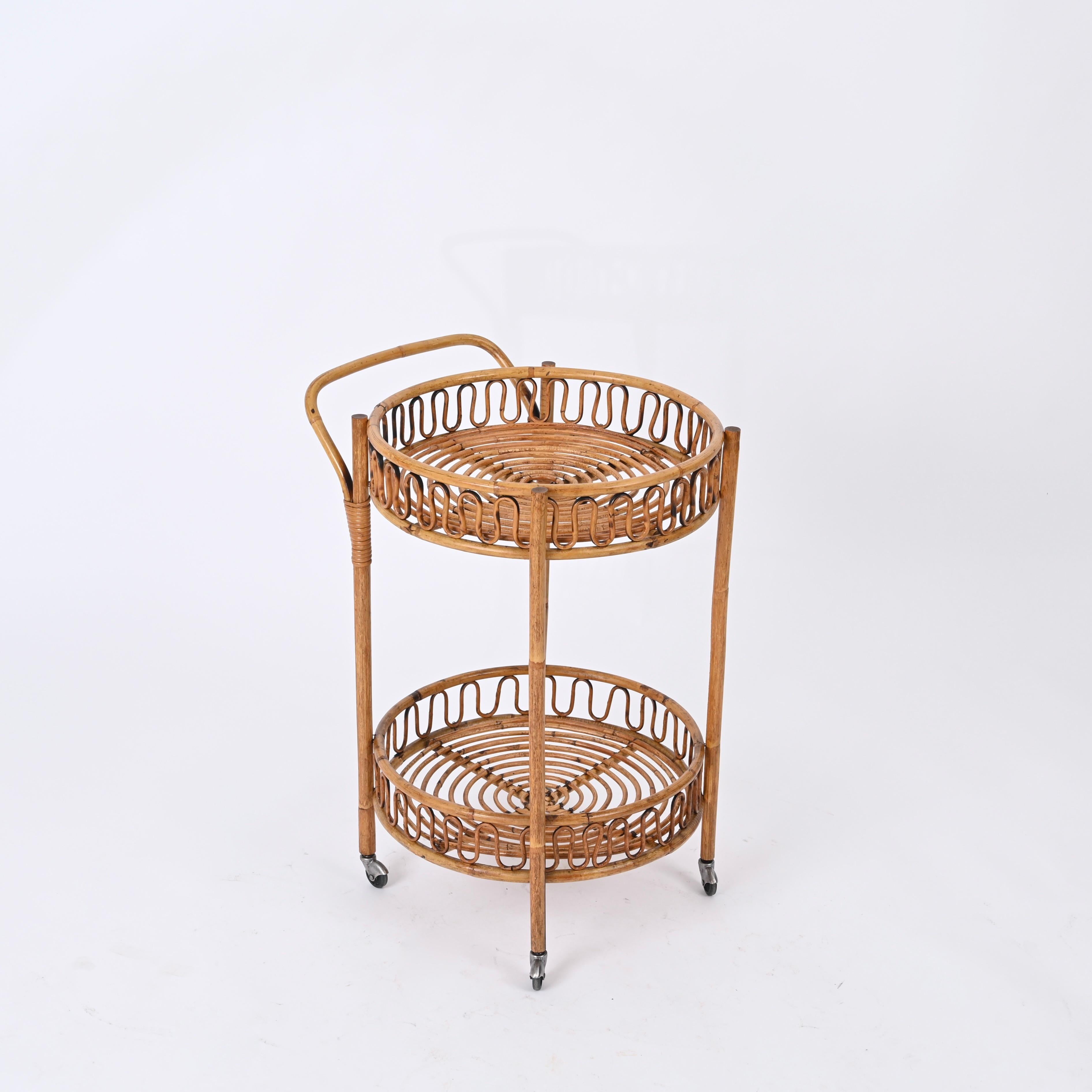 Stunning Mid-Century round bar cart trolley fully made in bamboo, curved rattan and hand-woven wicker. This unique piece was hand-crafted during the 1960s in Italy. with perfect proportions, great example of fine Italian craftsmanship from the