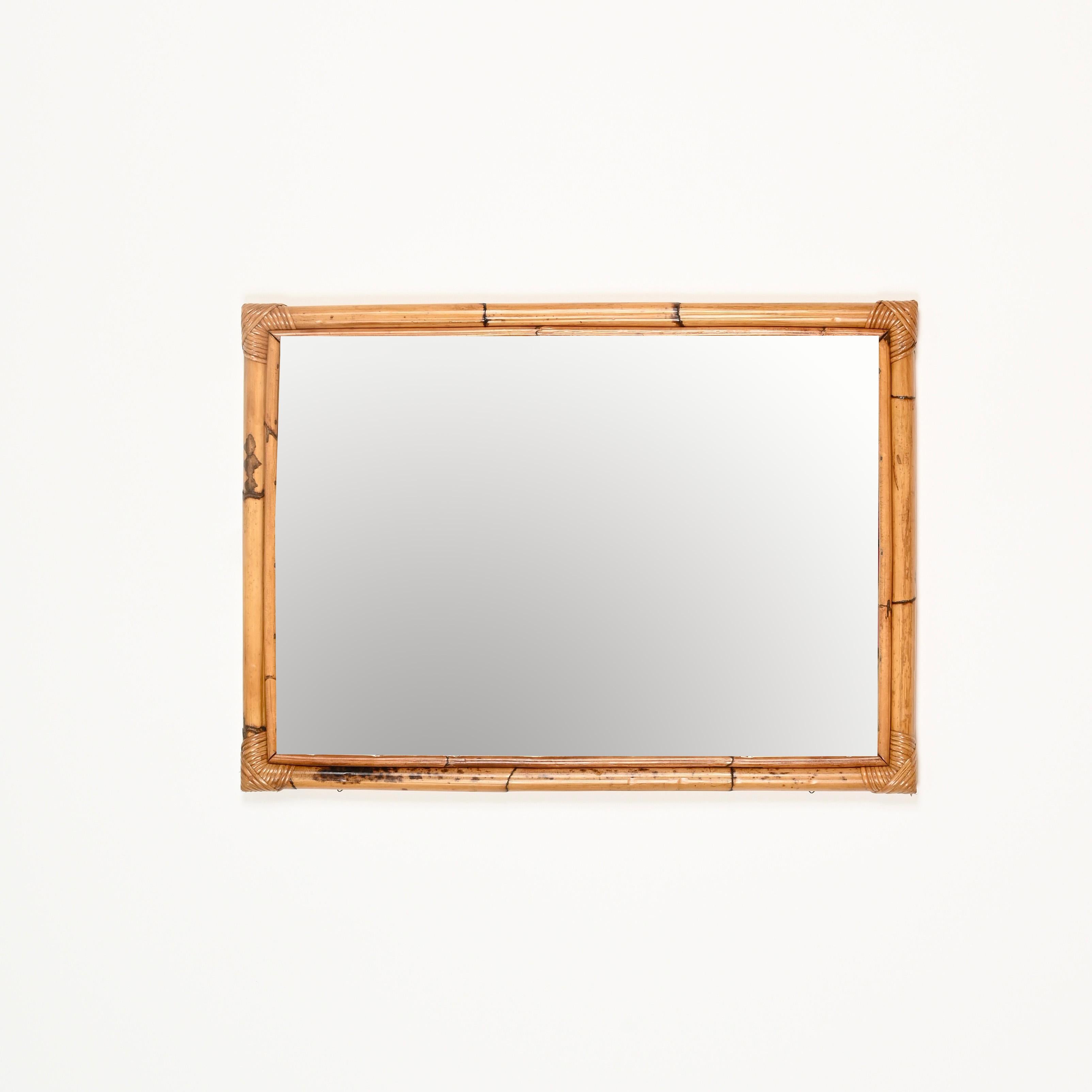 Gorgeous large Mid-Century rectangular mirror made of bamboo and hand-woven rattan wicker. This lovely French Riviera style mirror was handmade in Italy during the 1960s.

In amazing condition and featuring a beautiful warm tone, this charming