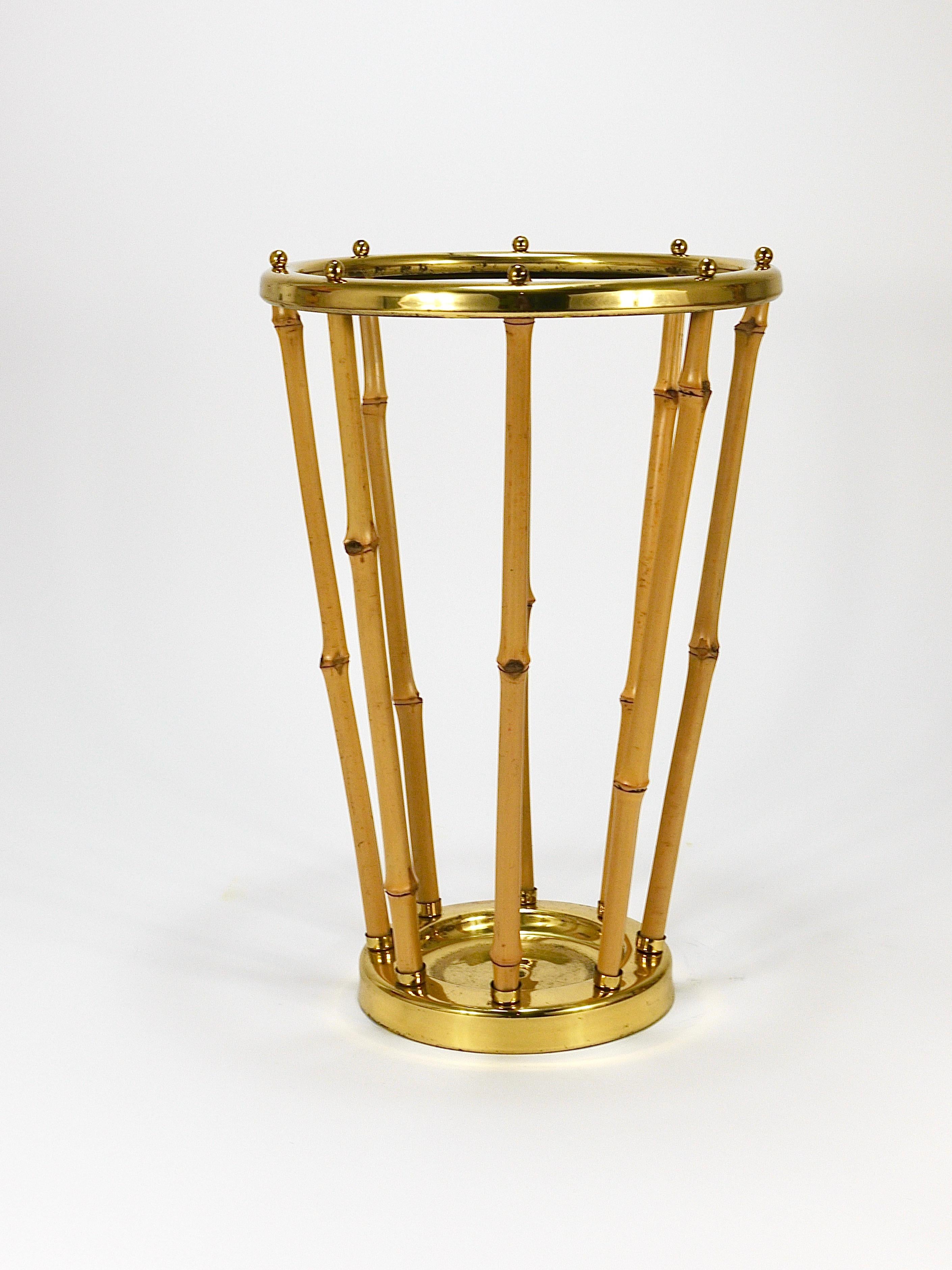 A beautiful Mid-Century Riviera-style umbrella stand from France, crafted in the 1950s. The base and top ring are made of brass, beautifully connected by decorative bamboo sticks, secured with charming little brass balls. The brass exhibits marginal