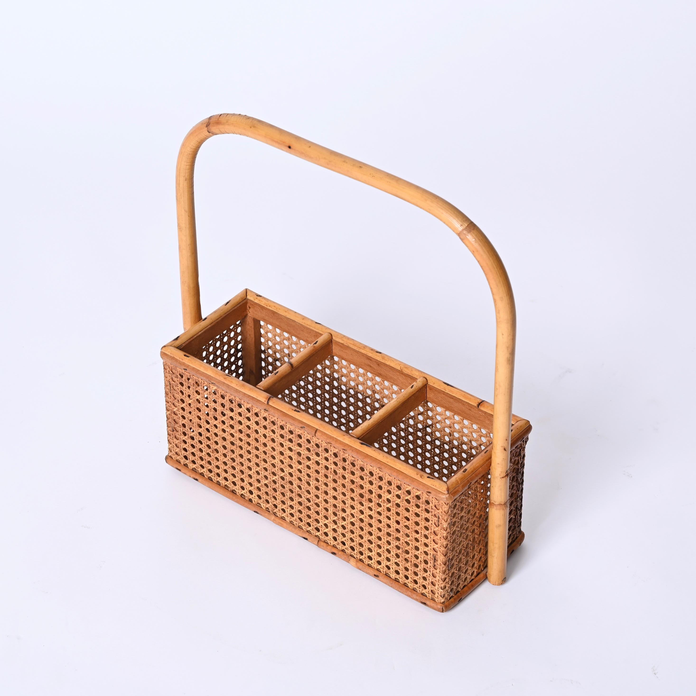 Lovely Mid-Century French Riviera style wine rack in rattan and Vienna Straw with handle in curved bamboo. This gorgeous piece was designed in Italy in the 1970s.

Fully hand-made with perfect proportions this beautiful bottle holder will complement
