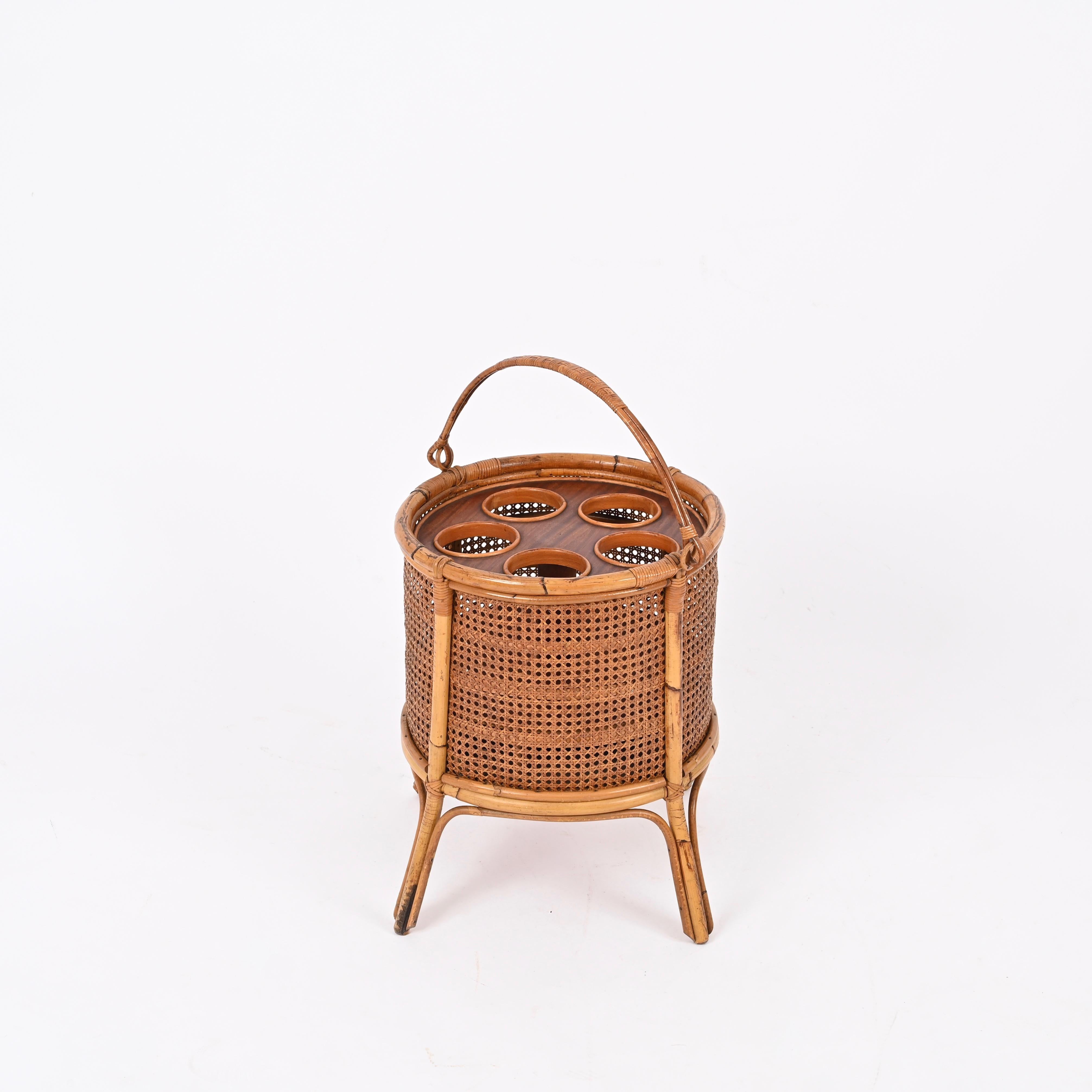 Delightful Mid-Century French Riviera style bottle holder made in a stunning combination of hand-woven Vienna straw, rattan, wicker and wood.  This unique piece was designed in Italy in the 1960s.

Completely handcrafted with perfect proportions,