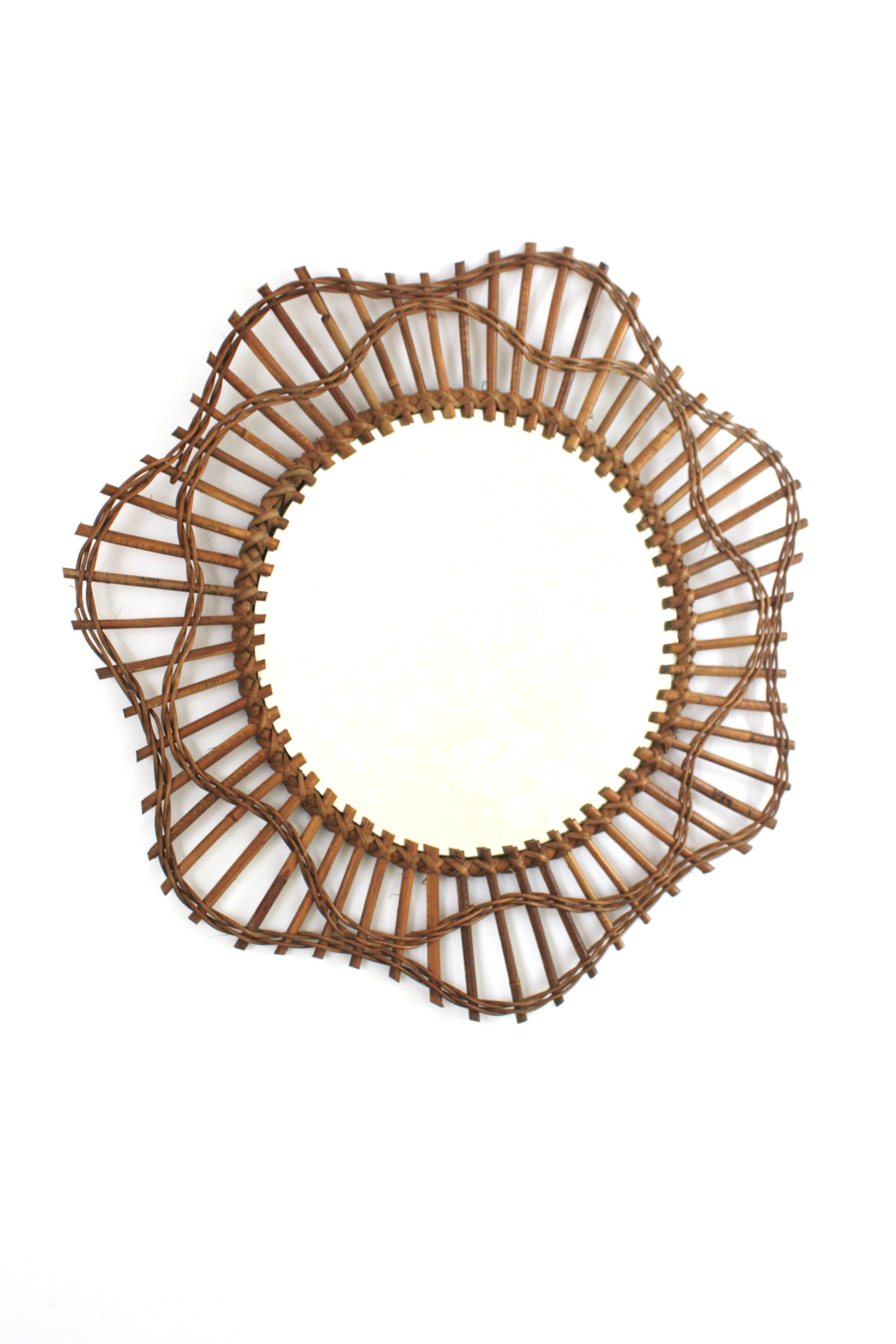 Rattan Wicker Flower Sunburst Mirror 
Handcrafted flower mirror with rattan and wicker frame, France, 1940-1950s
This eye-catching Mediterranean sunburst mirror was handcrafted in France at the fifties and it has all the taste of the French