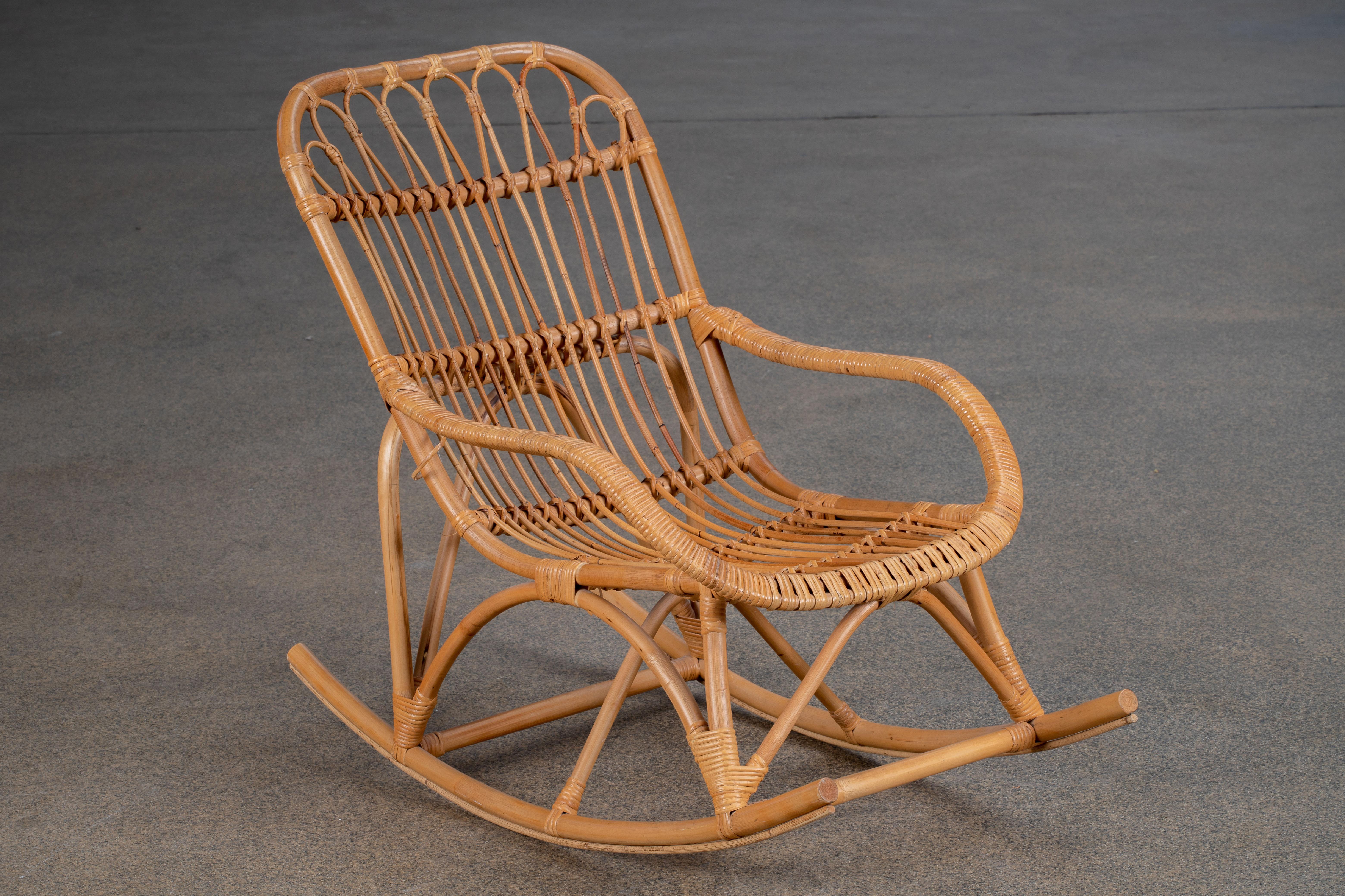 1960s oversized bamboo rattan Rocking chairs Handmade in the French Riviera organic modern style. The chairs feature a large bent rattan frame. Very comfortable with excellent joinery and craftsmanship. Could also be used as patio garden