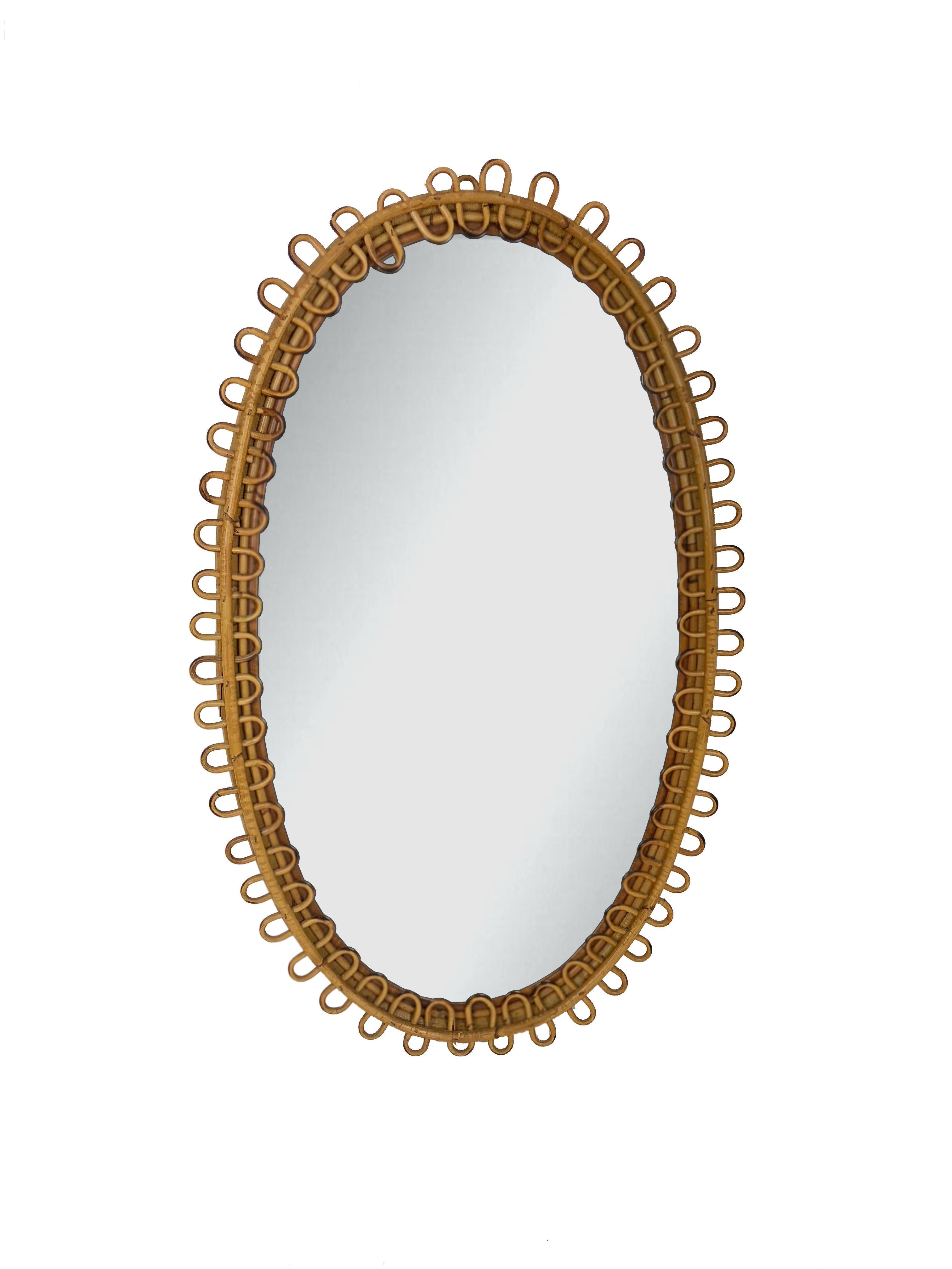 Charming French Riviera rattan mirror. The undulating border is reminiscent of many Jean Royère designs.