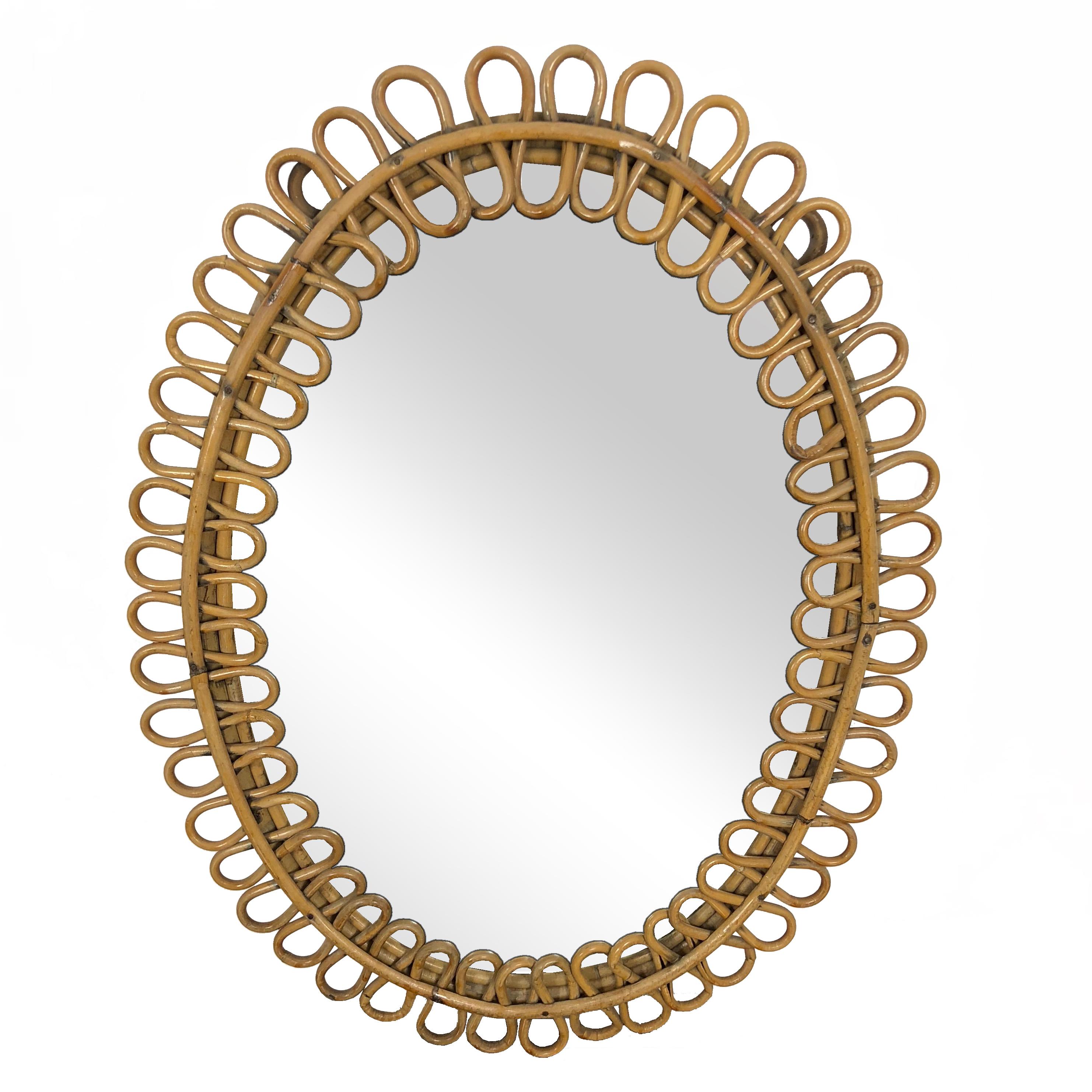 Charming French Riviera rattan mirror. The undulating border is reminiscent of many Jean Royère designs.