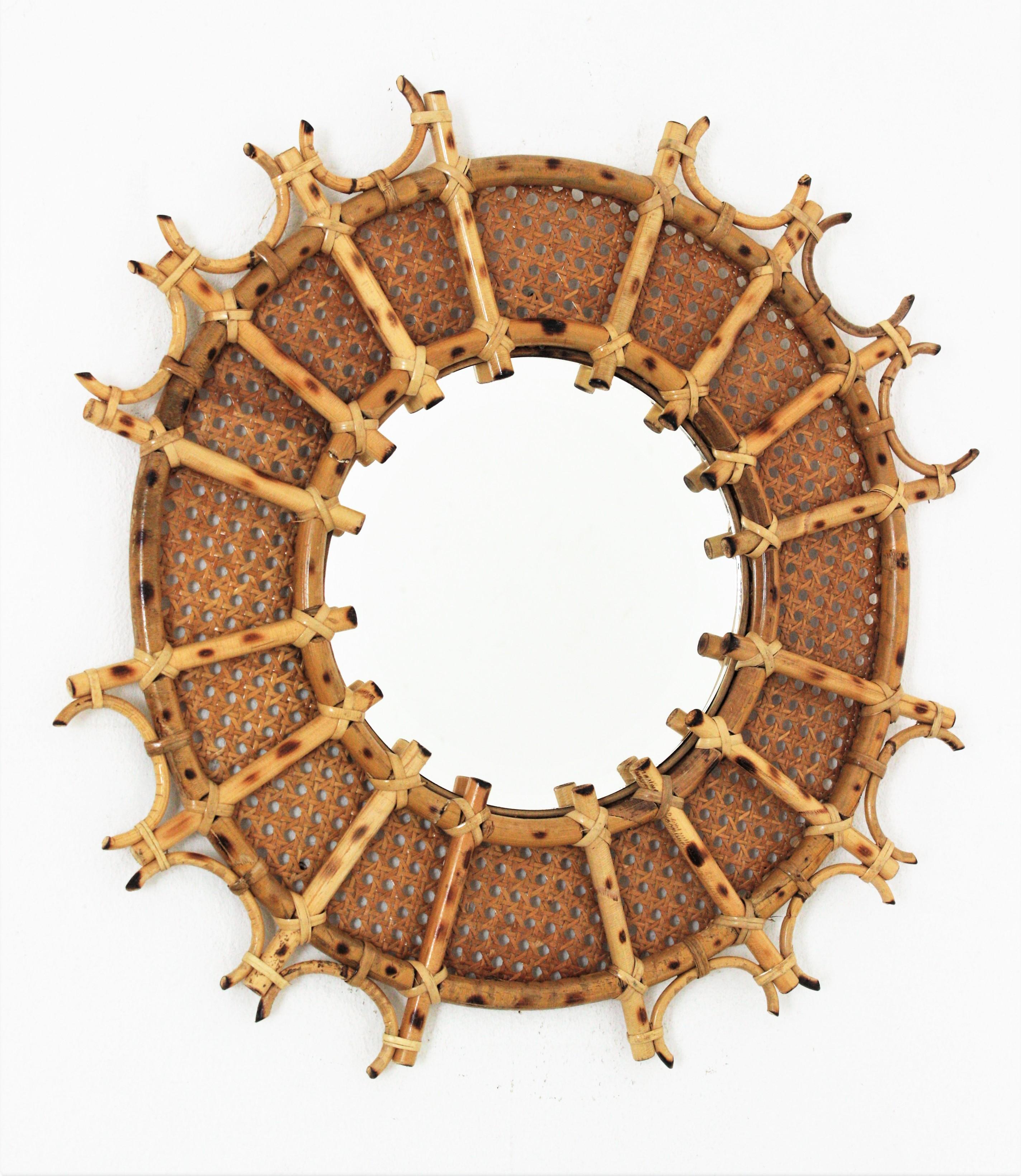 French Riviera Modernist handcrafted Rattan sunburst mirror. France, 1960s
Mediterranean style handcrafted sunburst rattan and wicker weave mirror. Unusual design.
This mirror has a highly decorative caning frame with rattan canes in sunburst