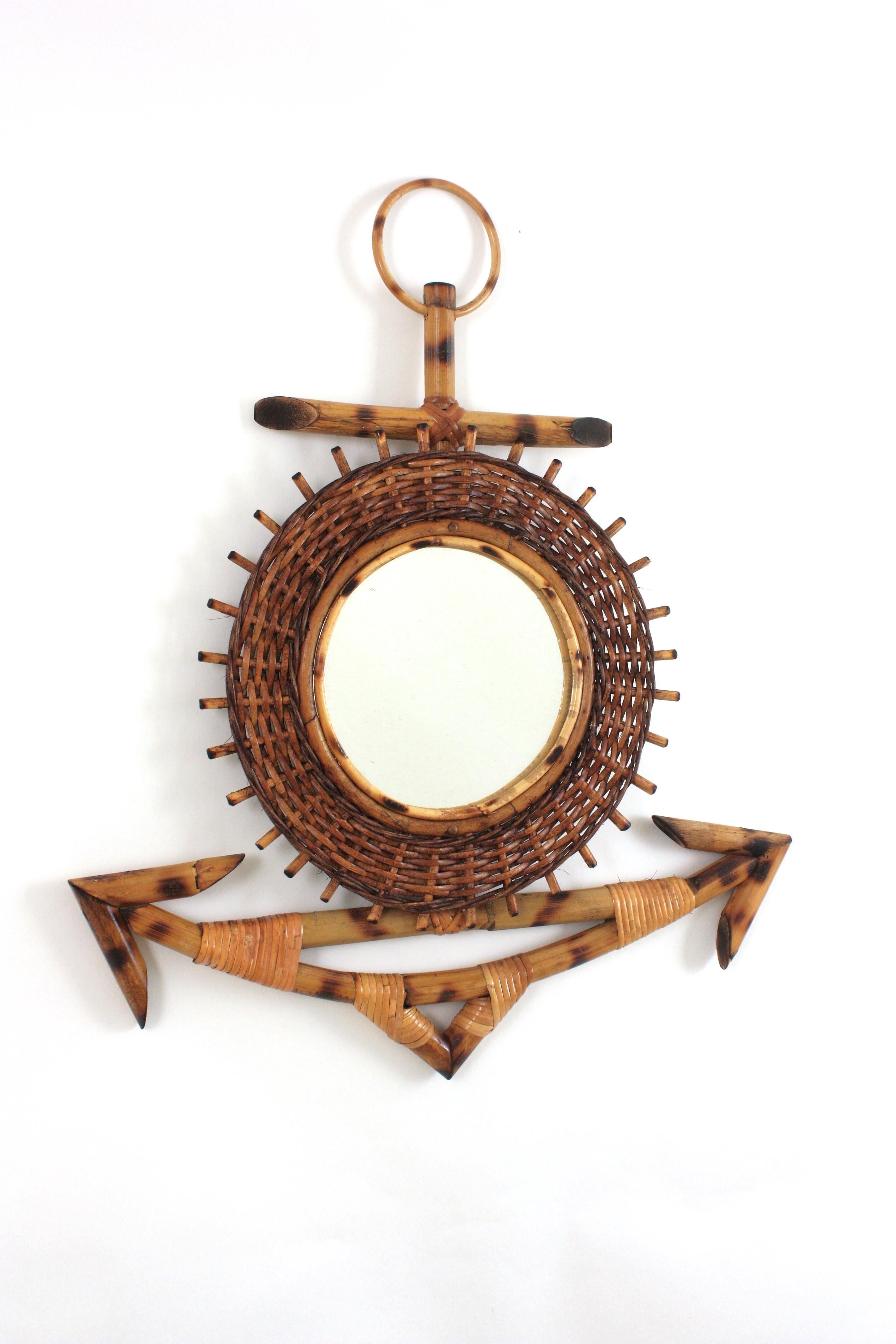 One of a kind rattan and bamboo handcrafted anchor shaped wall mirror. France, 1950s
This handmade bamboo mirror features an anchor with a flower sunburst mirror at the central part. It has a rare design and it has all the taste and freshness of the