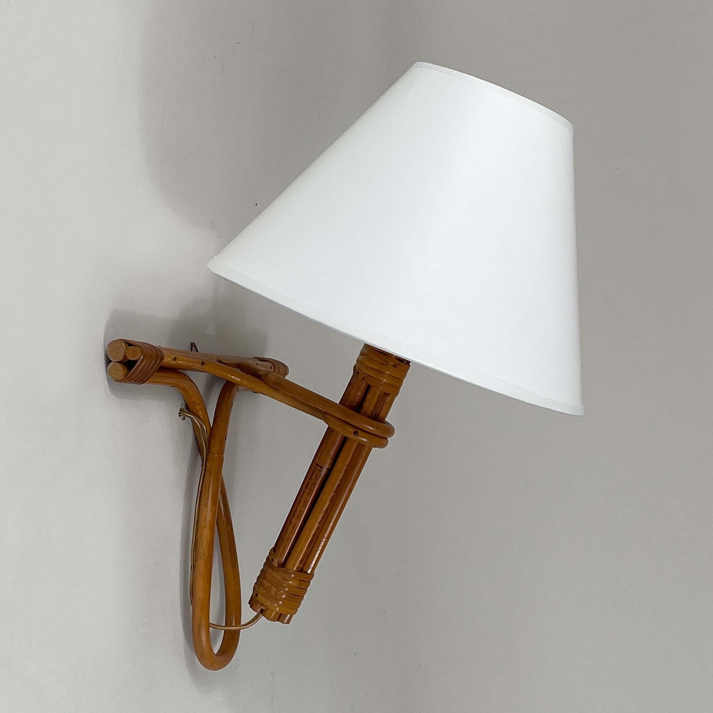 This mid-century French Riviera wall light was designed and manufactured in France in the 1950s to 1960s by French designer Louis Sognot.

The light features a design made primarily from bamboo/rattan and wicker, giving it a natural and rustic look.