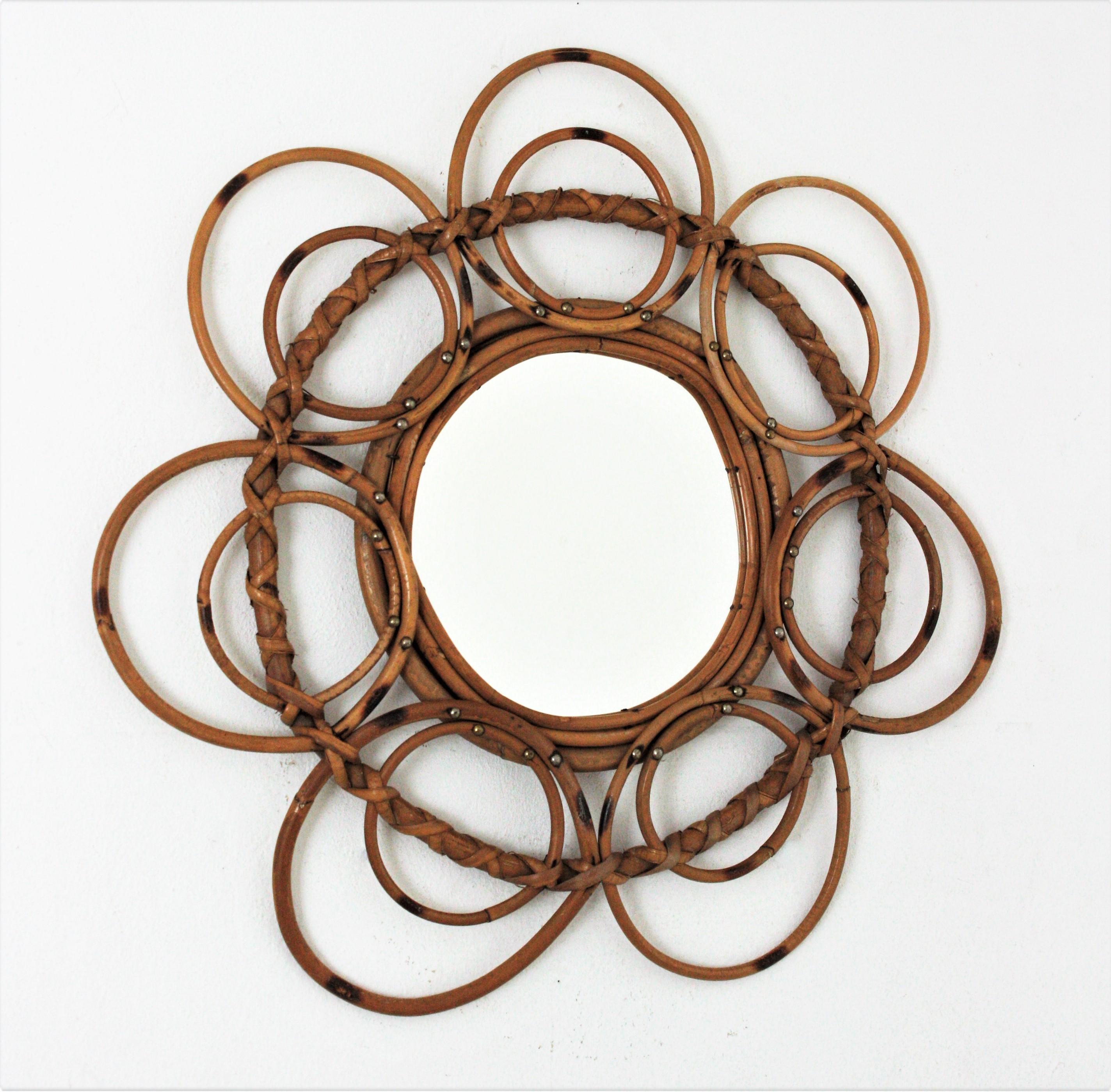 Wall mirror or flower mirror, rattan, bamboo, France, 1960s
French Riviera rattan mirror framed by concentric circles displayed as petals creating a flower shaped mirror.
This mirror has all the taste of the Midcentury french coast style. It will