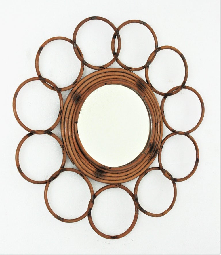 Rattan Round Flower Mirror, France, 1960s
This handcrafted mirror is framed with circles and it has pyrography decorations on the frame.
It is in very good vintage condition and it has all the taste of the Mediterranean French coast style.
It will