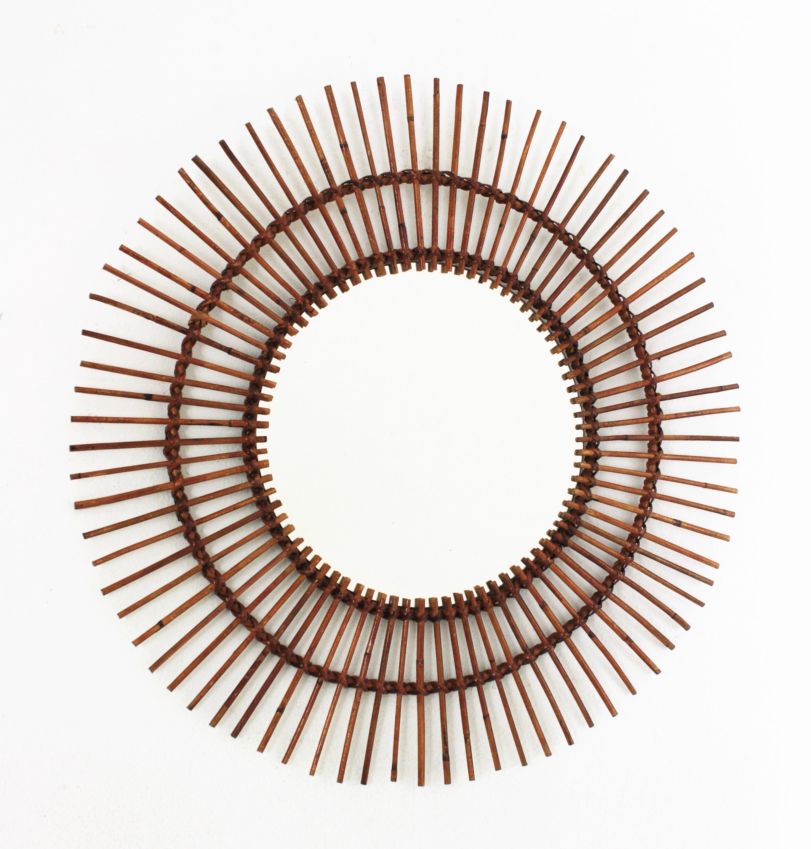 A beautiful handcrafted rattan starburst mirror with pyrography decorations on the rays. France, 1960s.
This mirror can add all the freshness of the Mediterranean French Riviera style to any countryside/beach house decoration. It can be also