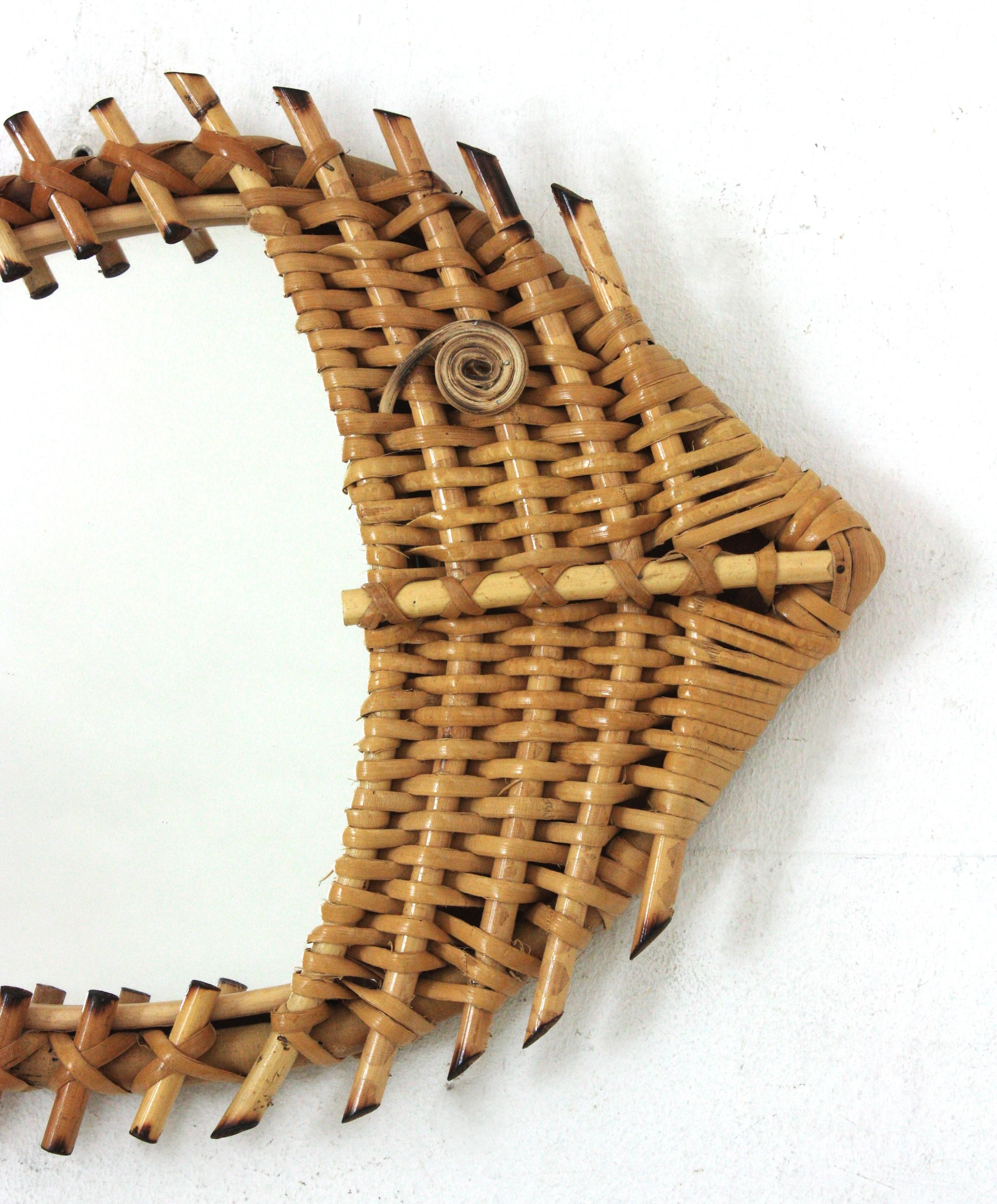 Fish Figure Rattan and Woven Wicker Wall Mirror, France, 1950s-1960s.
Rare find.
Eye-catching fish shaped wall mirror. Hand-crafted in rattan with hand-woven wicker work on the body.
This spectacular mirror has a design combining the Midcentury