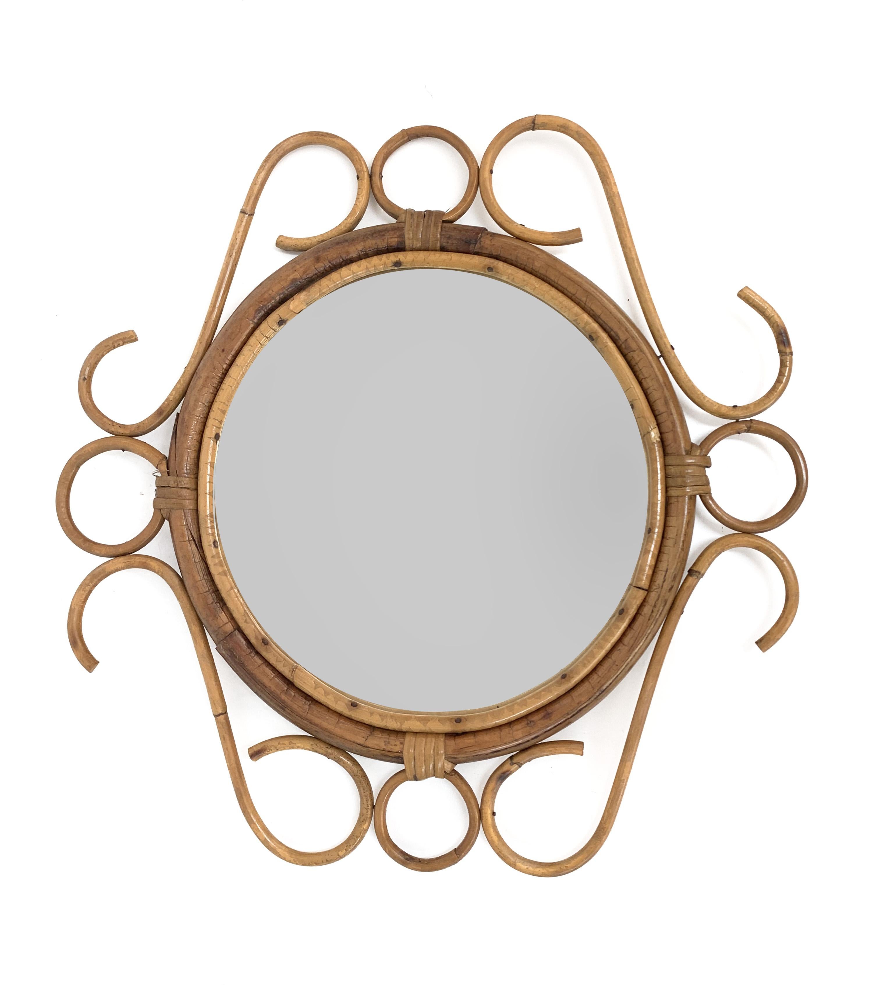 Cote d'Azur round wall mirror with bamboo and rattan frame, made in France in the 1960s. It is attributed to the craftsmanship of Franco Albini.

This fantastic mirror is in its original and good condition. It has the unmistakable design of the