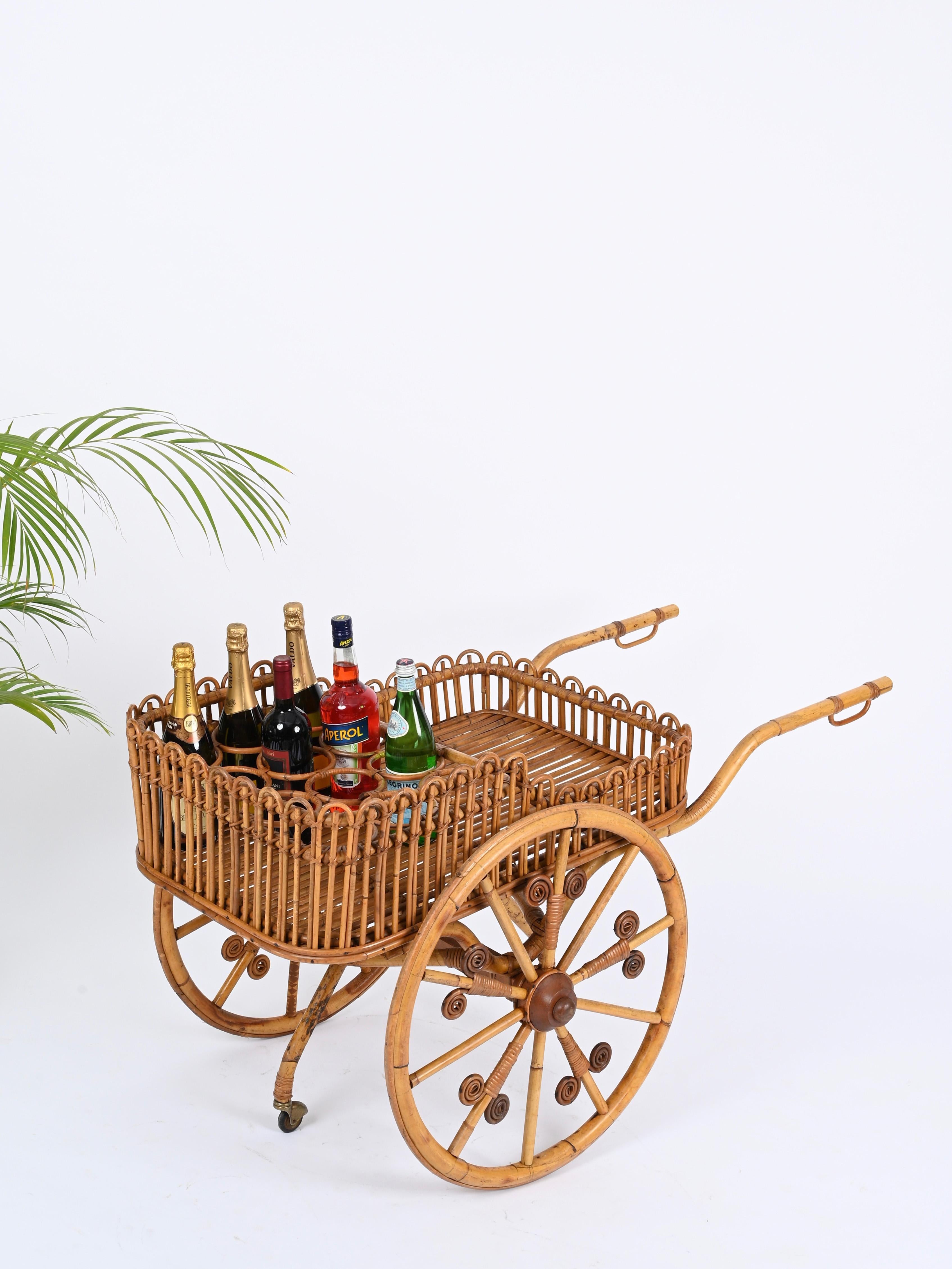 Magnificent Mid-Century French Riviera style bar cart  with bottle fully made in curved bamboo, rattan and woven wicker. This gorgeous serving bar cart was hand-made in Italy during the 1960s. 

This stunning and unique piece was fully hand-made
